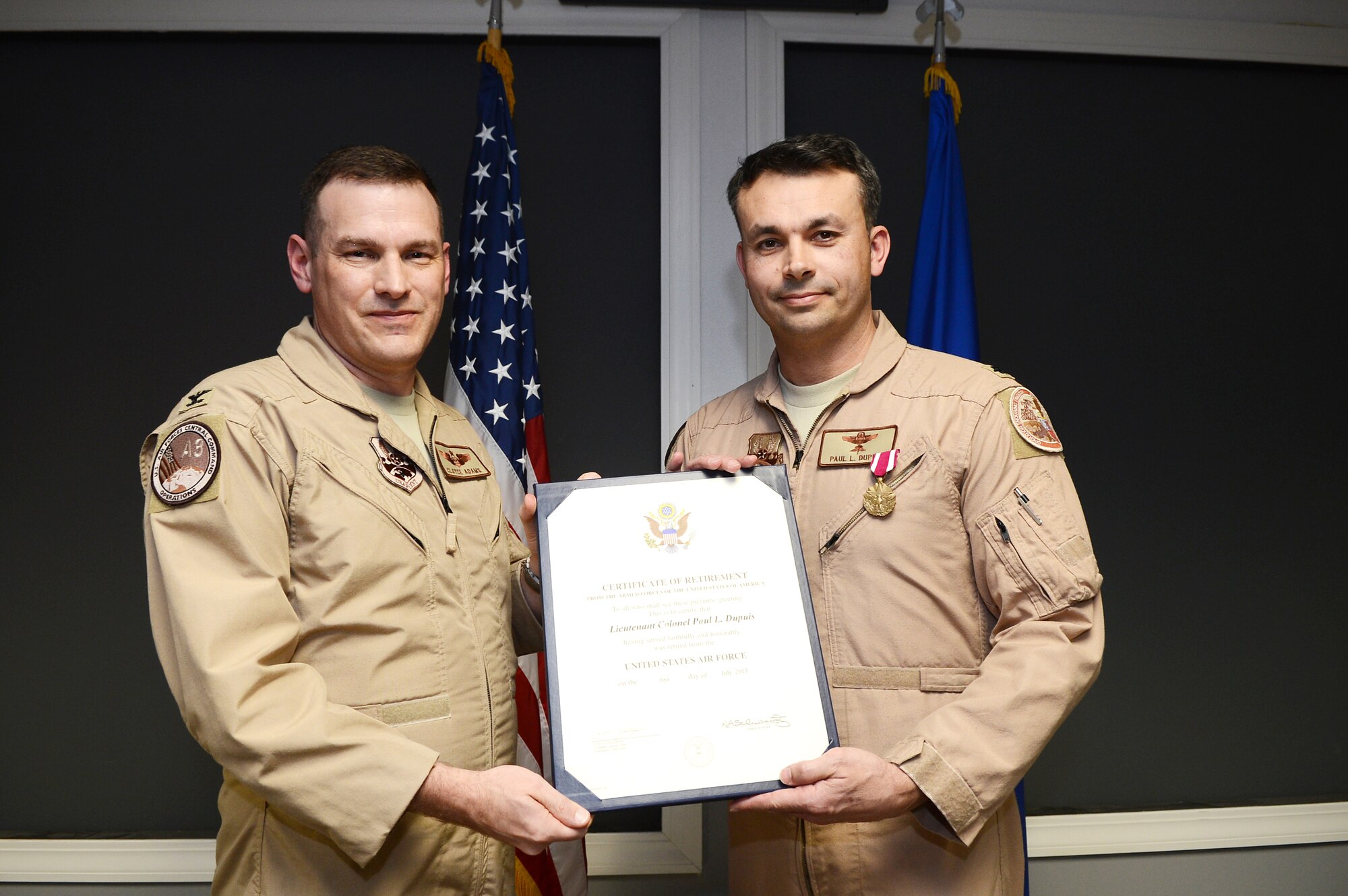 U.S. Air Force Lt. Col. Paul Dupuis, U.S. Air Forces Central deputy chief of plans and requirements, receives his certificate of retirement after more than 20 years of service at Shaw Air Force Base, S.C., March 8, 2013.  Dupuis enlisted in the summer of 1988 when he joined as pararescuemen.  In 1995, Dupuis crossed over to the ranks of a commissioned officer through Boston University's Reserve Officer Training Corps Program.  (U.S. Air Force photo by Airman 1st Class Nicole Sikorski/Released)