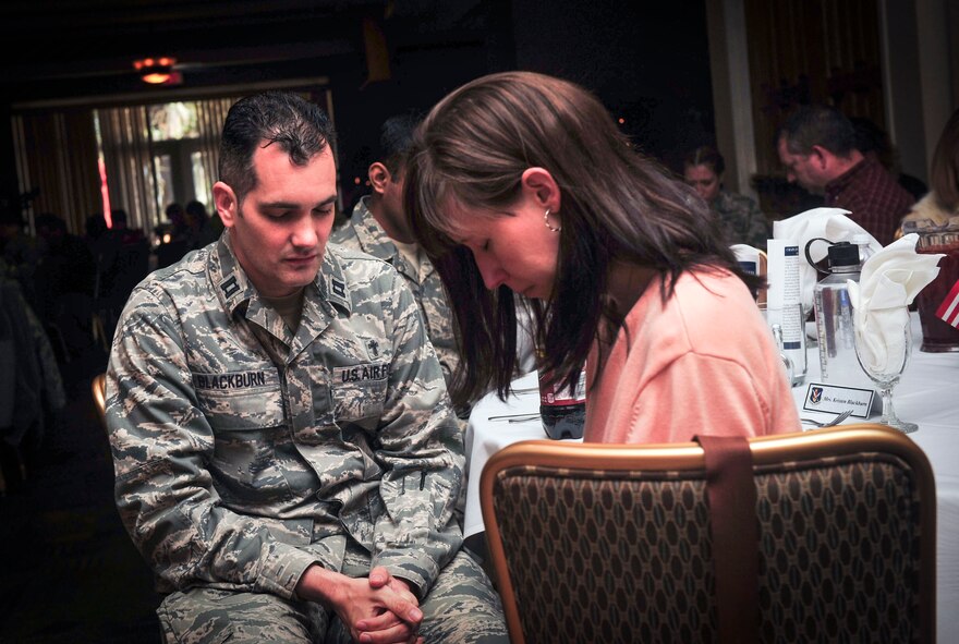 U.S. Air Force Chaplain (Capt.) Jeremiah Blackburn, a chaplain for the 23d Wing Chapel, bows his head to pray during Moody’s National Prayer Luncheon at Moody Air Force Base, Ga., March 7, 2013. The National Prayer Luncheon is celebrated in conjunction with the National Prayer Breakfast, which has been celebrated by every U.S. president since 1953. (U.S. Air Force photo by Senior Airman Jarrod Grammel/Released)
