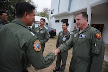U.S. Air Force Lt. Col. David Eaglin, right, commander of the 44th Fighter Squadron at Kadena Air Base, Japan, greets Royal Thai Air Force and Republic of Singapore Air Force military counterparts before a multilateral in-brief during Cope Tiger 13 Field Training Exercise at Korat Royal Thai Air Force Base, Thailand, March 10, 2013. The annual exercise, comprised of aviation and ground units, is designed to enhance interoperability and relations amongst each nations air forces. More than 300 U.S. service members are participating in CT13, which offers an unparalleled opportunity to conduct a wide spectrum of large force employment air operations and strengthen military-to-military ties with two key partner nations, Thailand and Singapore. (U.S. Air Force photo/2nd Lt. Jake Bailey) (Released)