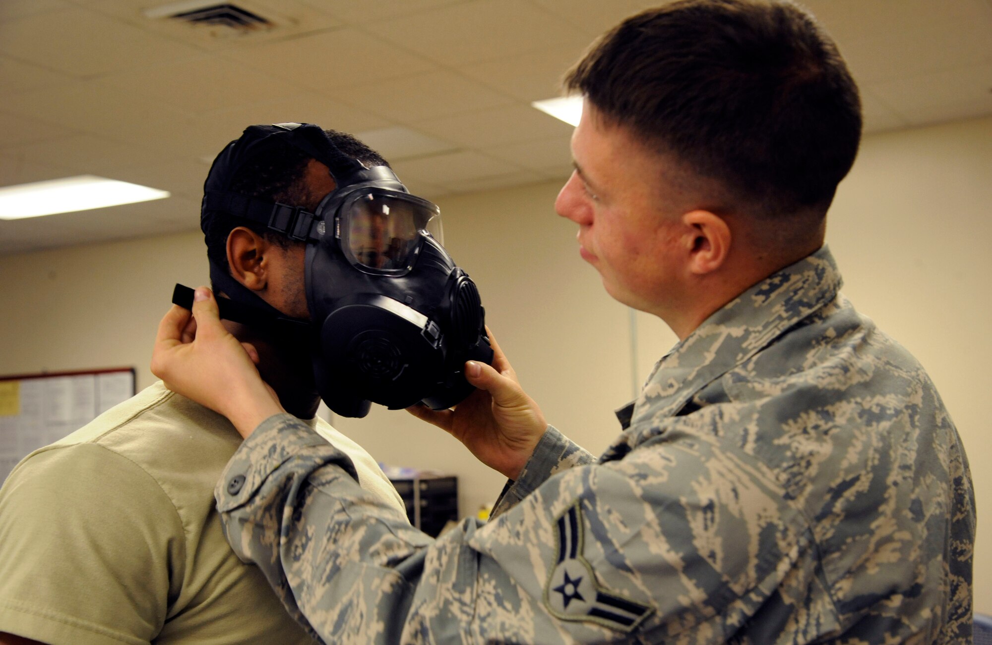Airmen 1st Class Ryan Latchaw and Melvin Jenkins, 2nd Logistics Readiness Squadron Mobility Flight, test gas mask seals during routine equipment maintenance on Barksdale Air Force Base, La., March 11. All equipment must be properly maintained to upkeep its serviceability. Routine inspections and removal of expired gear ensures an Airman's survival while at a deployed location. (U.S. Air Force photo/Airman 1st Class Andrew Moua)