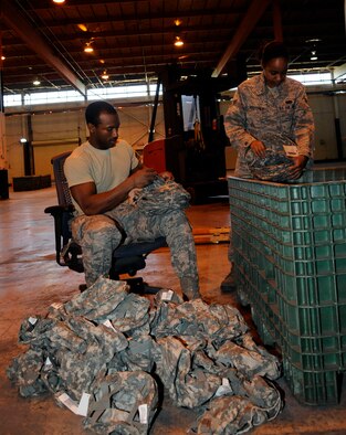 Airmen 1st Class Melvin Jenkins and Burgundy Rostchild, 2nd Logistics Readiness Squadron Mobility Flight, inventory helmet covers on Barksdale Air Force Base, La., March 11. The mobility flight is responsible for issuing and maintaining mission essential equipment to deploying Airmen, such as gas masks, weapons and body armor. (U.S. Air Force photo/Airman 1st Class Andrew Moua)