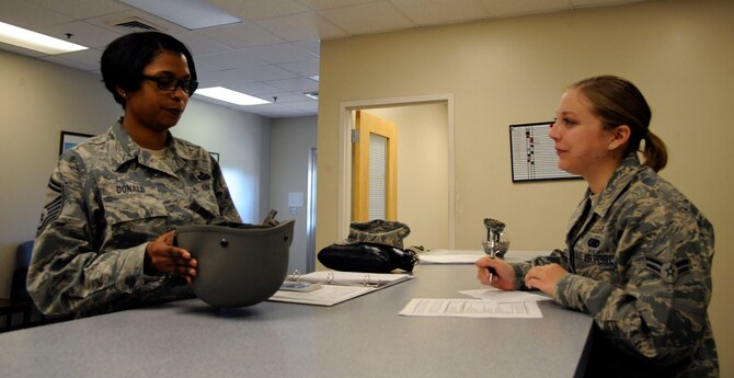 Airman 1st Class Alexis Stiles, 2nd Logistics Readiness Squadron Mobility Flight, issues gear to Senior Master Sgt. Bonita Donald, Air Force Global Strike Command, on Barksdale Air Force Base, La., March 11. The mobility office issues gear ranging from body armor, Mission Oriented Protective Posture gear, helmets and gas masks to Airmen who are getting ready to deploy. (U.S. Air Force photo/Airman 1st Class Andrew Moua)