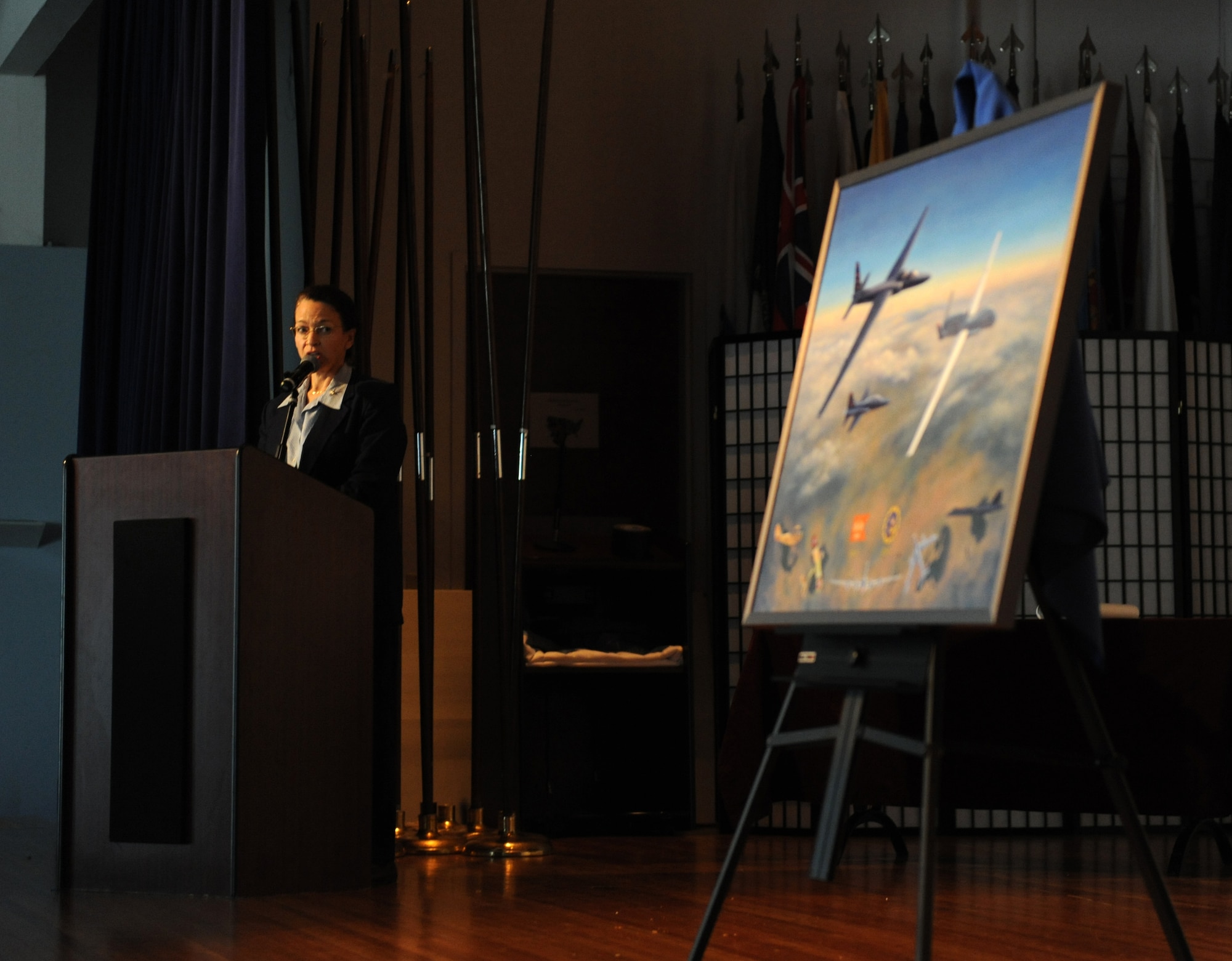 Aviation artist Kristin Hill speaks about her painting depicting the centennial of the 1st Reconnaissance Squadron at Beale Air Force Base, Calif., March 7, 2013. Hill has painted more than 250 aviation art paintings and has work featured in many international airports as well as the Pentagon. (U.S. Air Force photo by Staff Sgt. Robert M. Trujillo/Released)