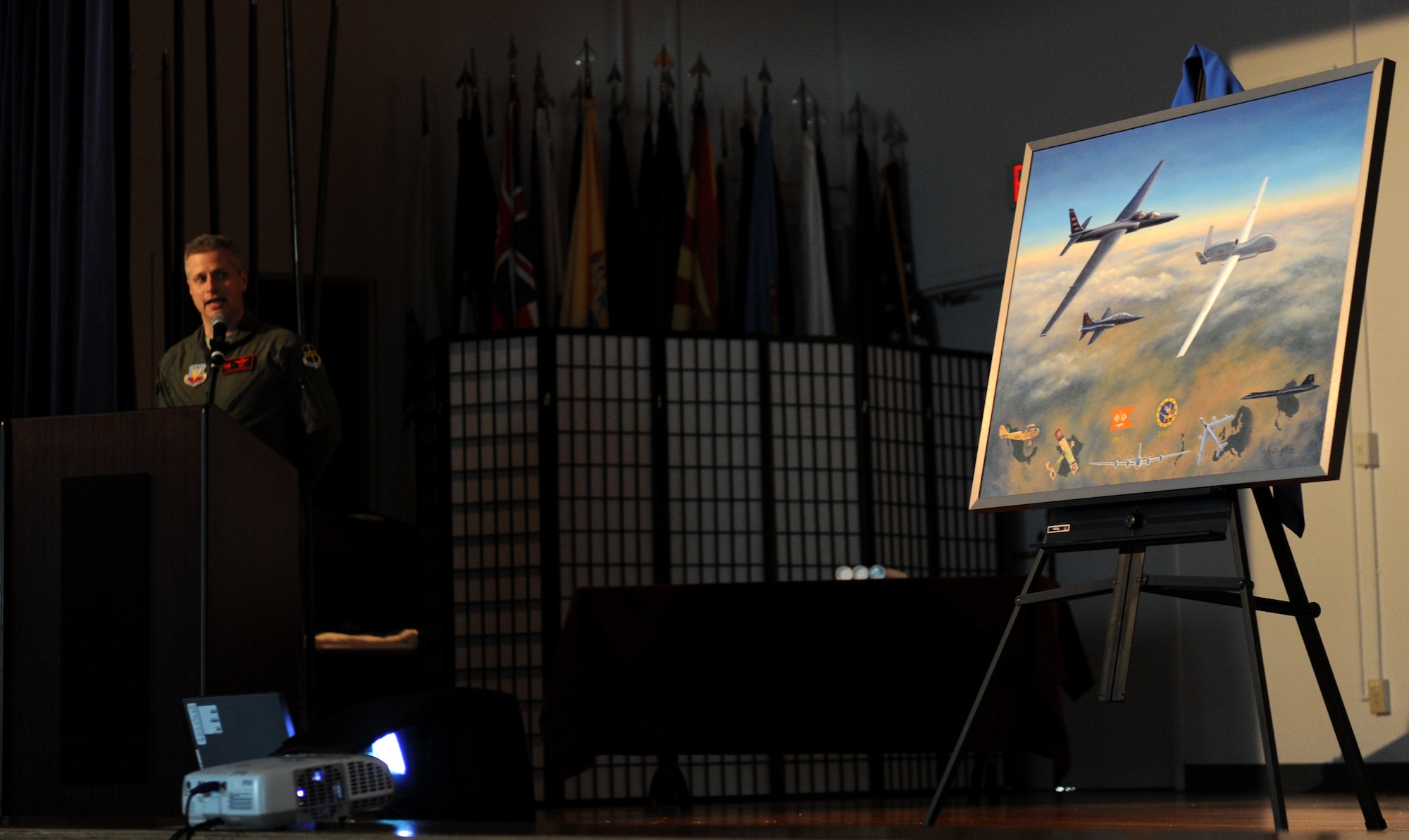 Lt. Col. Stephen Rodriguez, 1st Reconnaissance Squadron commander, talks about the commemorative painting of the 1st RS centennialat Beale Air Force Base, Calif., March 7, 2013. The art was painted by Kristin Hill, an aviation artist and participant of the U.S. Air Force Art Program. (U.S. Air Force photo by Staff Sgt. Robert M. Trujillo/Released)