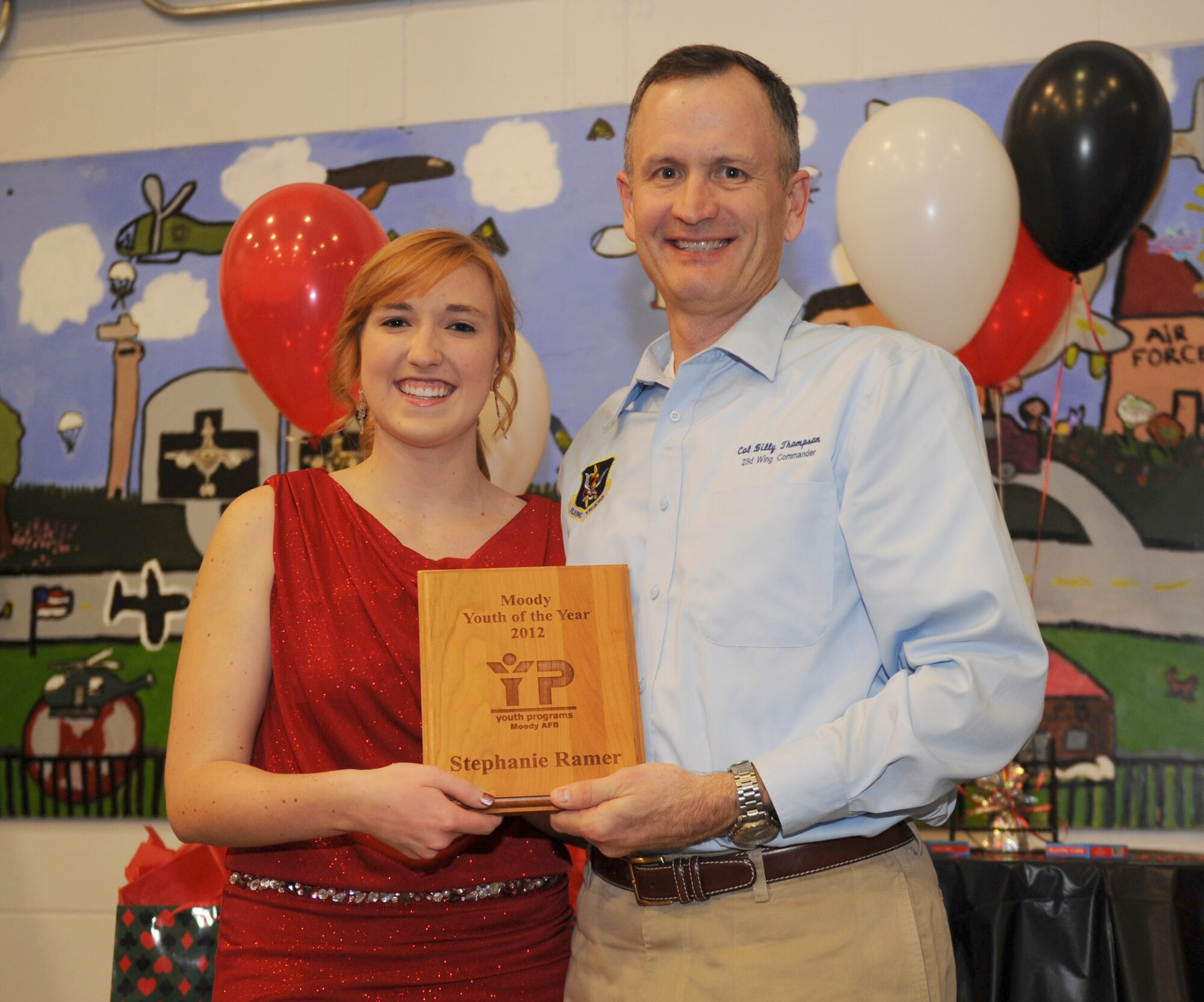 U.S. Air Force Col. Billy Thompson, 23d Wing commander, and Stephanie Ramer pose for a photo during a Youth of the Year Celebration in the Youth Center at Moody Air Force Base, Ga., Mar. 8, 2013. Ramer was chosen as Moody’s Youth of the Year and will be going to Atlanta to compete for the state of Georgia. (U.S. Air Force photo by Airman 1st Class Olivia Bumpers/Released)