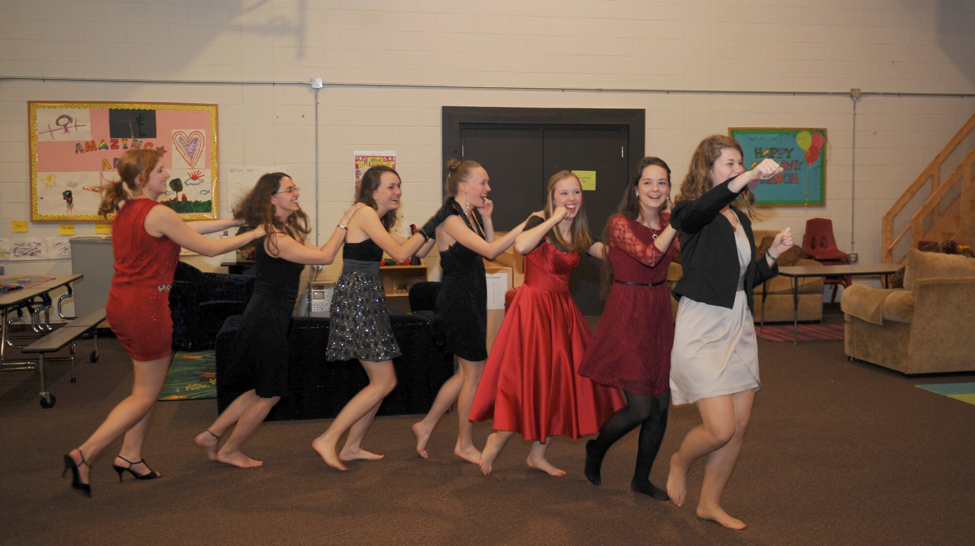 Stephanie Ramer and her friends form a conga line during a Youth of the Year Celebration in the Youth Center at Moody Air Force Base, Ga., Mar. 8, 2013. Family and friends gathered at the center to celebrate her accomplishment of being named Moody’s Youth of Year. (U.S. Air Force photo by Airman 1st Class Olivia Bumpers/Released)