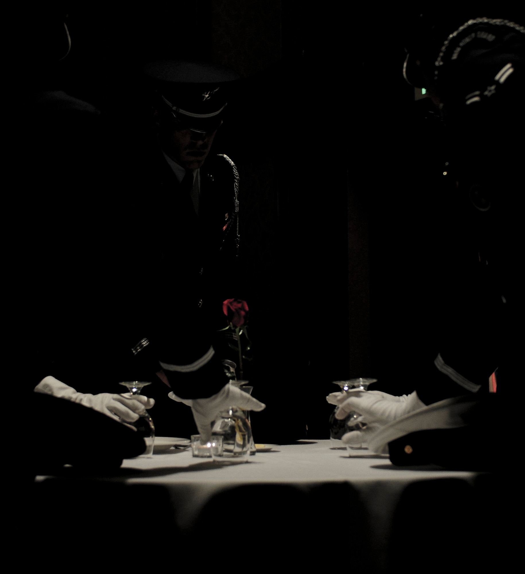 The Beale Air Force Base Honor Guard prepares the POW/MIA table during the 1st Reconnaissance Squadron Centennial celebration at the Sheraton Grand Hotel in Sacramento, Calif., March 9, 2013. (U.S. Air Force photo by Senior Airman Allen Pollard/Released)