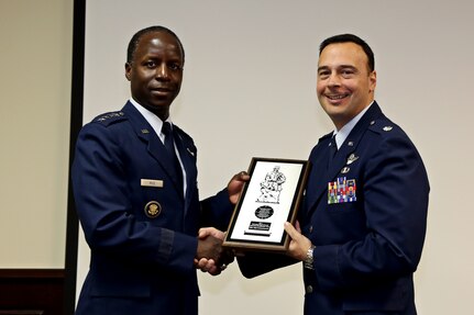 Gen. Edward Rice Jr., Commander of Air Education and Training Command, presents the 2011 Col. Joseph B. Duckworth Annual USAF Instrument award to Lt. Col. Scott Cerone, 558th Flying Training Squadron commander, at Joint Base San Antonio-Randolph, Texas March 8, 2013.  The 558th FTS' remotely piloted aircraft instrument qualification team earned the award for their efforts in developing the first pilot instrument qualification course for RPA operations. The program leverages existing joint primary pilot training courseware and extensive use of simulators.  (U.S. Air Force Photo by Josh Rodriguez)