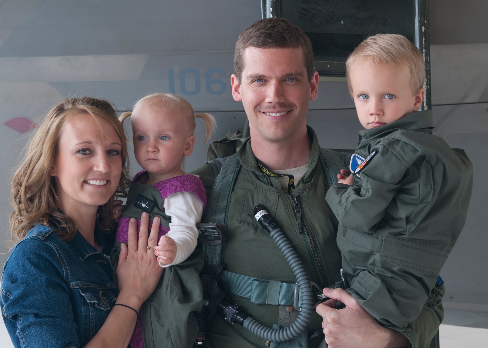 Erin Graf wife of Major Ryan Graf, 7th Fighter Squadron F-22 Raptor pilot, joins her husband along with thier two children son Brayden, and daughter Kaylee, at Holloman Air Force Base N.M., March 6. Graf has been absent from flying for 6 months due to back complications that resulted in surgery. Graf along with his family and friends joined together to celebrate his first post-surgery flight, and cheer him on as he takes off back in to the skies. (U.S. Air Force photo by Airman 1st Class Leah Murray/Released) 
