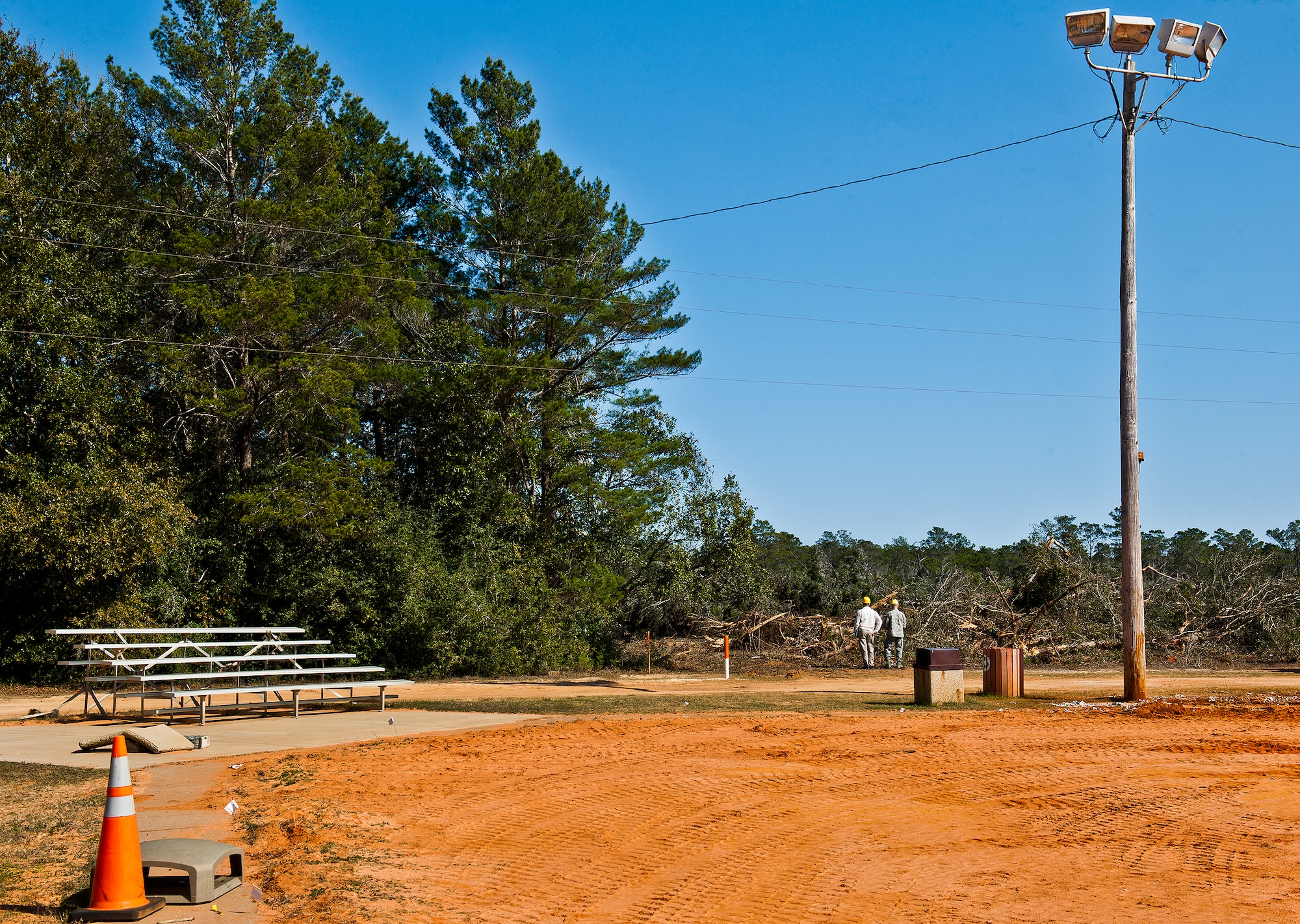 Members of the 96th Force Support Squadron survey the area where a new multi-purpose field will go along with tennis and basketball courts as part of a large on-going athletic area renovation at Eglin Air Force Base, Fla. This is one of many renovations taking place surrounding the track and field house behind the East Gate shopette.  All of the ball fields will be upgraded with new dugouts and fencing.  One of them will be converted to a multi-purpose field.  The concrete PT pads will be coated in rubber urethane.  Also, a covered pavilion area will be constructed between Foster Stadium and the soccer field.  These projects are to support the increased PT activity in the area, according to the 96th Force Support Squadron.  The expected completion date is late 2013.  (U.S. Air Force photo/Samuel King Jr.)