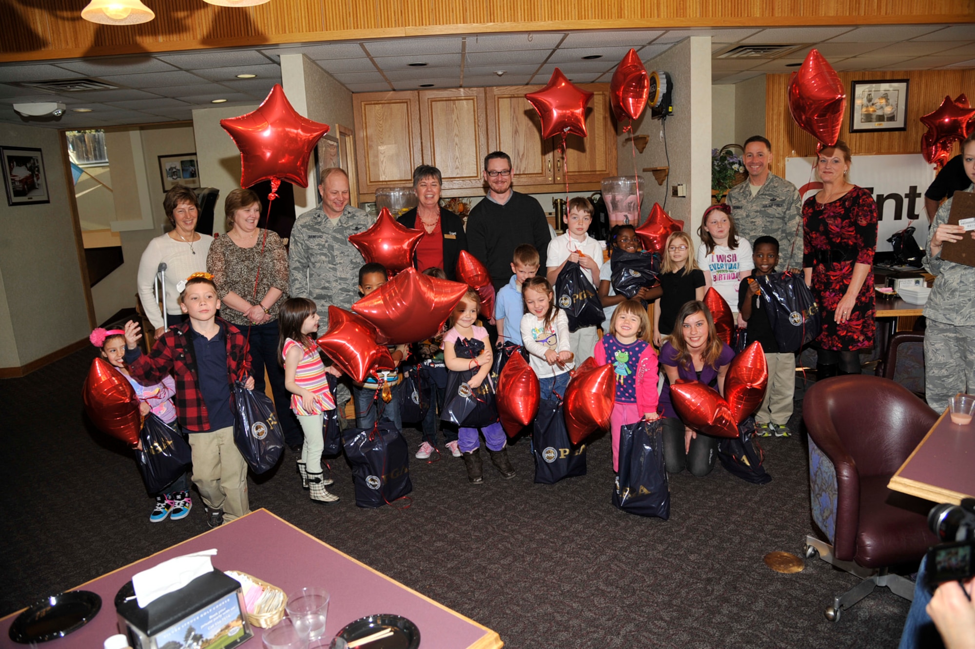 Kids from the child development center and the RP Lee Youth Center have a reception at the golf course as part of an art contest. The contest was a way to celebrate the Month of the Military Child in April and the start of play this year at the new Family Golf Course. (U.S. Air Force photo)