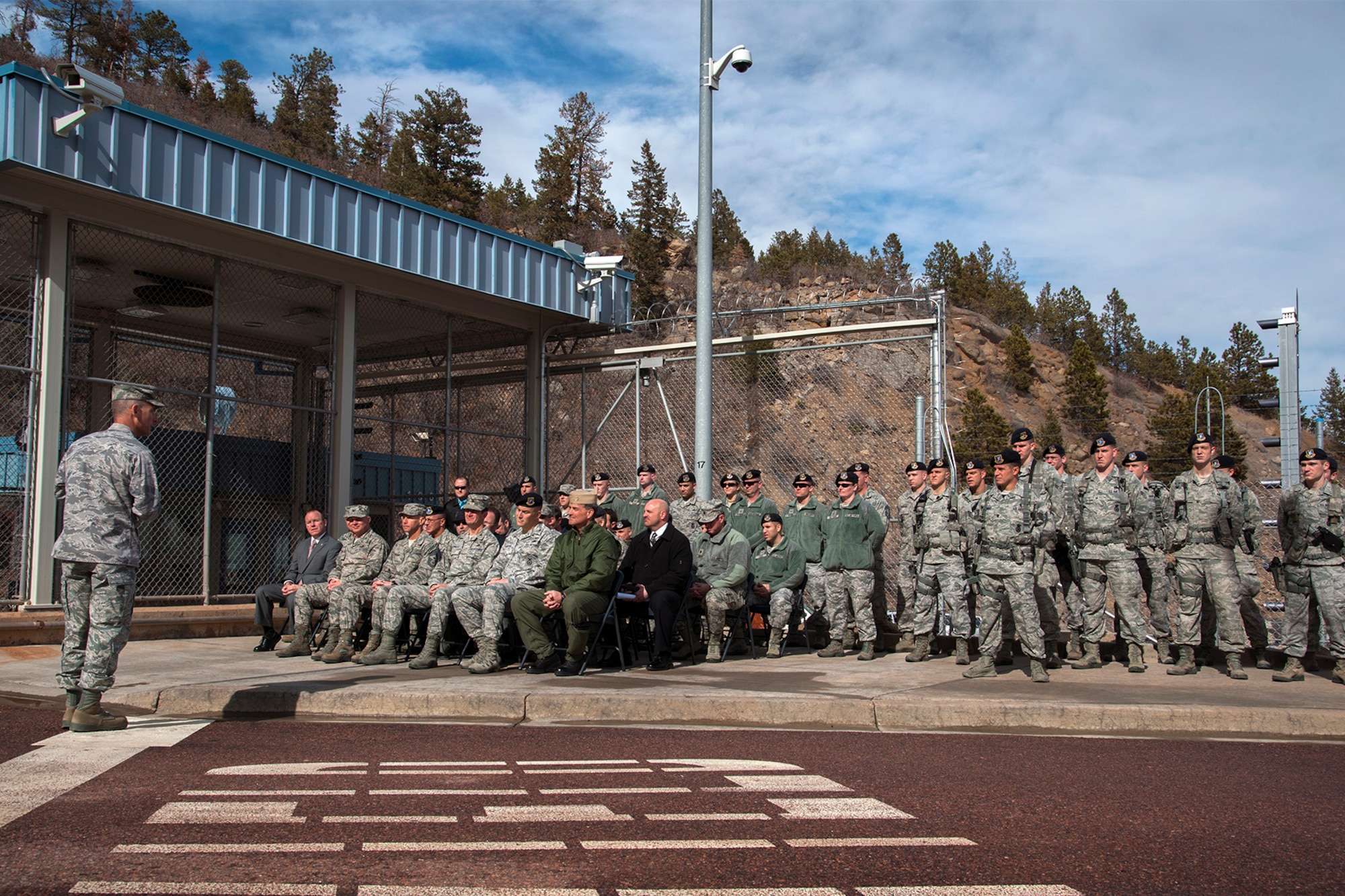 CHEYENNE MOUNTAIN AIR FORCE STATION, Colo. — Col. Joe Turk, 721st Mission Support Group commander, welcomes guests and members of the 721st Security Forces Squadron to the Echo-5 formal release ceremony Feb. 19. The event honored the service of Cheyenne Mountain Air Force Station’s security forces members who, since Spring 2009, were posted as a close boundary sentry to protect the restricted area perimeter. These members guarded the entrance to CMAFS during around-the-clock operations withstanding temperatures varying from -15 to 101 degrees Fahrenheit. A new certified intrusion detection system now monitors all activity, freeing vital resources to be utilized in other areas. (U.S. Air Force photo/Craig Denton)