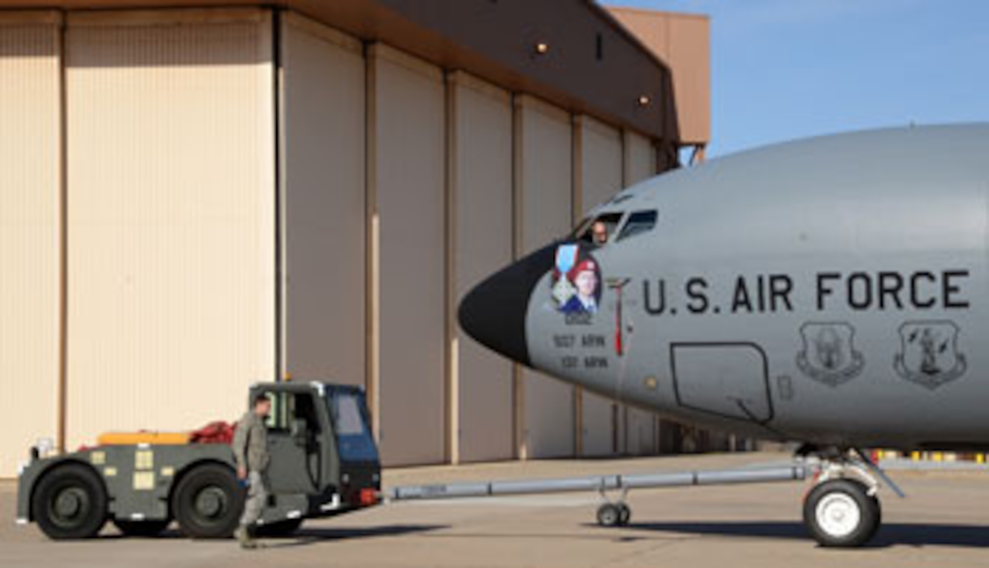 Tech. Sgt. Casey Ray operates the brakes on a KC-135 Stratotanker while it is being towed by Master Sgt. Robert Ahern (in the truck) to the trim pad to undergo engine runs. Staff Sgt. Vincent Peralta, walking, supervises the towing to ensure that all goes smoothly and safely. All three Airmen are crew chiefs with the 137th Aircraft Maintenance Squadron. (Air Force photo by Kelly White)
