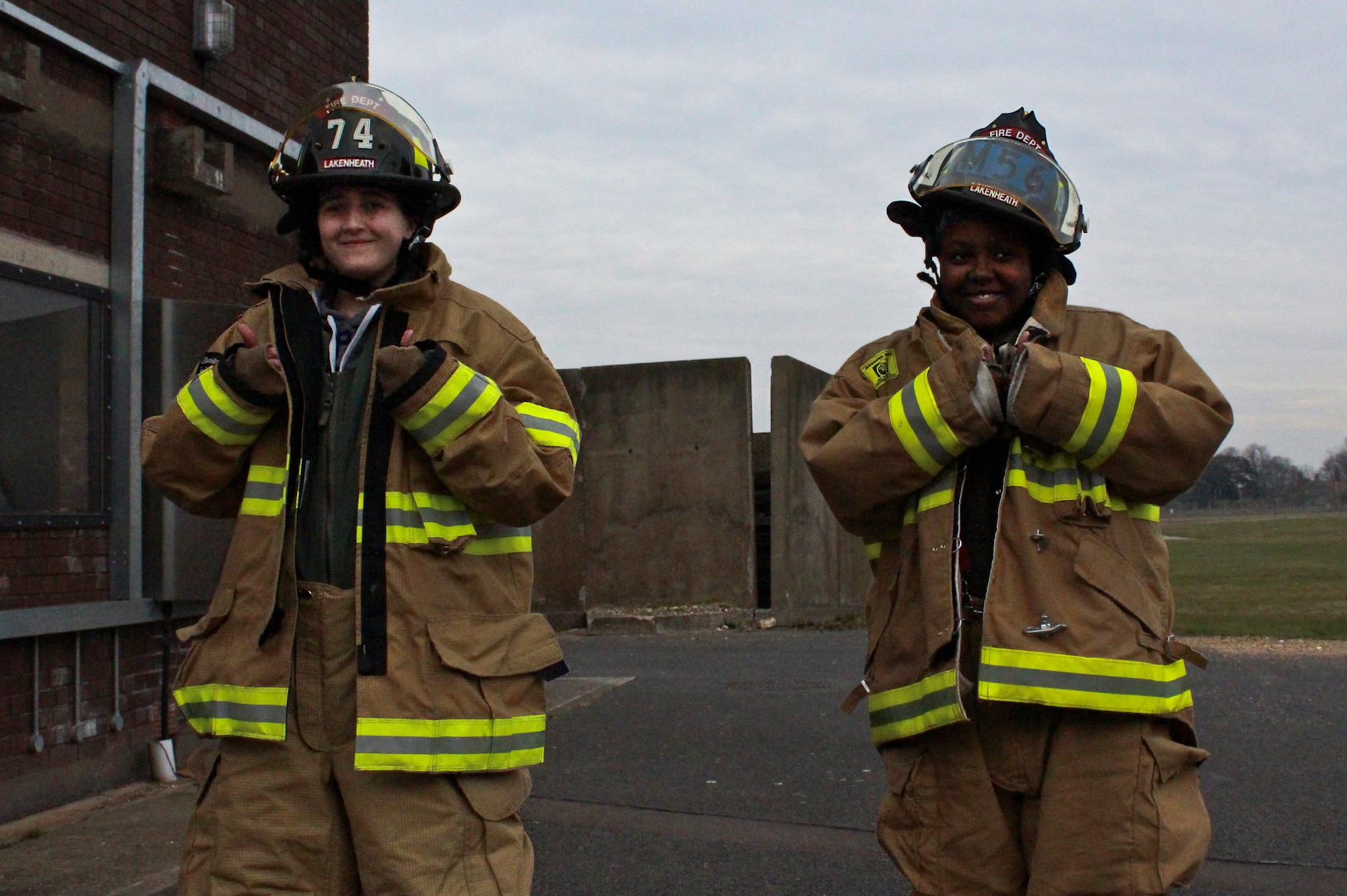ROYAL AIR FORCE LAKENHEATH, England – Ruth Putley (left), 16, and Lauren Cummings (right), 12, don firefighter gear during a fire demonstration with 48th Civil Engineer Squadron fire fighters as part of their “Pilot for a Day” experience March 6, 2013. During the event the two local children received special-made flight suits, a flight in an F-15 simulator, an interactive squadron tour, a birds of prey demonstration and an up-close viewing of an F-15C Eagle and an HH-60G Pave Hawk. (U.S Air Force photo by 2nd Lt. Keenan Kunst) 