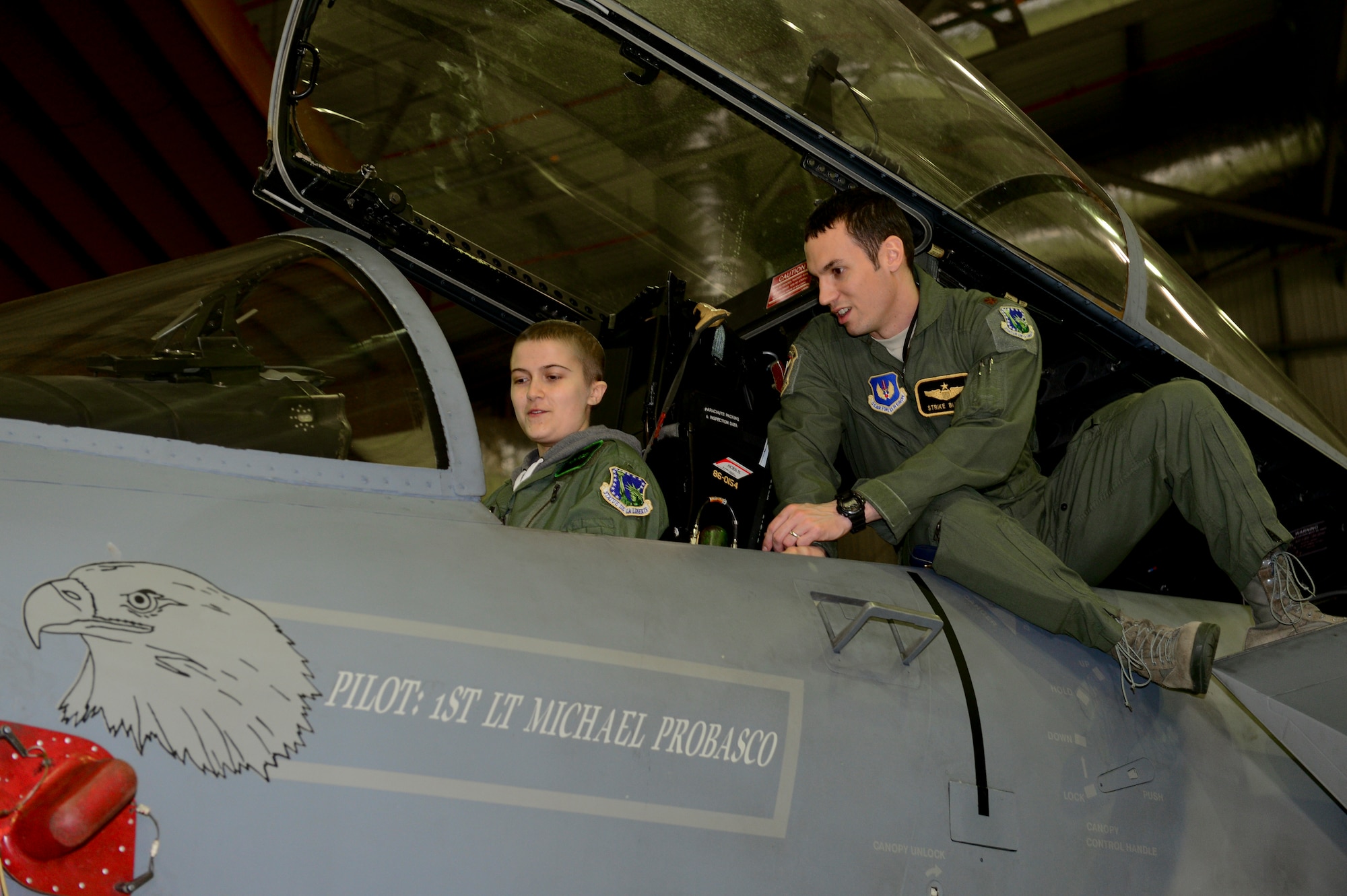 ROYAL AIR FORCE LAKENHEATH, England – Maj. Jason Bianchi, 493rd Fighter Squadron pilot, shows Ruth Putley, 16, the cockpit of an F-15C Eagle during a “Pilot for the Day” event March 6, 2013. The program started at RAF Lakenheath in March 2012 with the intent to assist children throughout local communities who are fighting life-threatening illness or conditions by providing a day of fun and allowing for a break from the routine doctor and hospital visits. (U.S. Air Force photo by Staff Sgt. Stephanie Mancha)