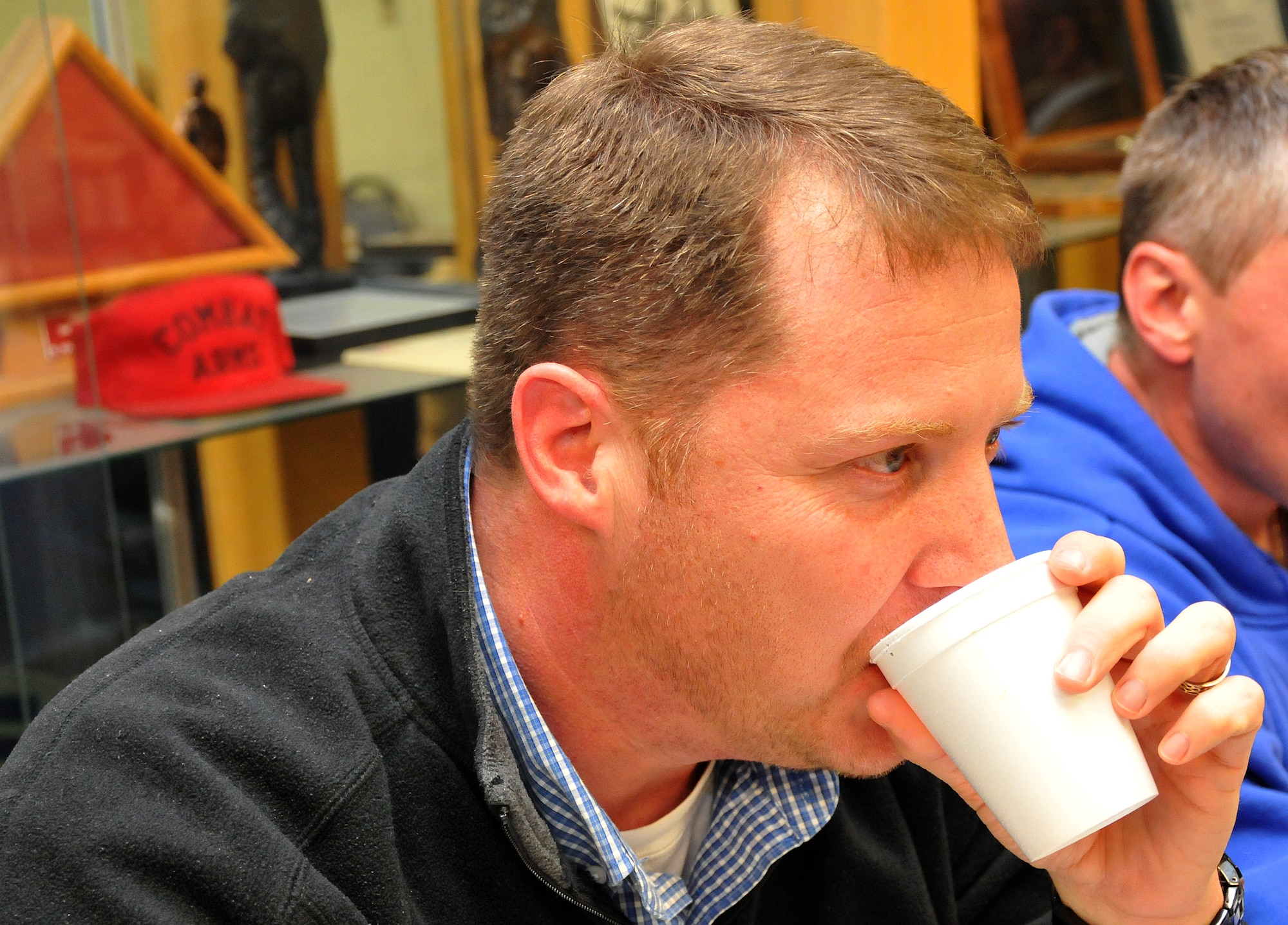 Neil Bethune, 94th Airlift Wing antiterrorism officer, gulps down water after tasting chili he claims is so spicy it could be used as biological agent. The Third Annual 94th Security Forces Squadron Chili Cook-off was guarded against tampering at the 94th SFS building on Dec. 12. (U.S. Air Force photo/Senior Airman Elizabeth Van Patten)