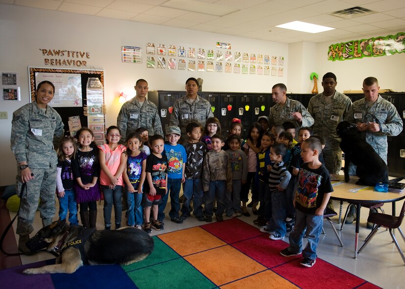 Dyess Airmen pose with kindergarteners from Martinez Elementary School during a school visit March 7, 2013, in Abilene, Texas. During the visit, children had the opportunity to interact with Airmen from security forces, maintenance and public affairs. The Airmen talked to the children about their jobs and why they joined the Air Force. At the end of the visit, students read letters to the Airmen thanking them for their service. (U.S. Air Force photo by Airman 1st Class Damon Kasberg/ Released)
