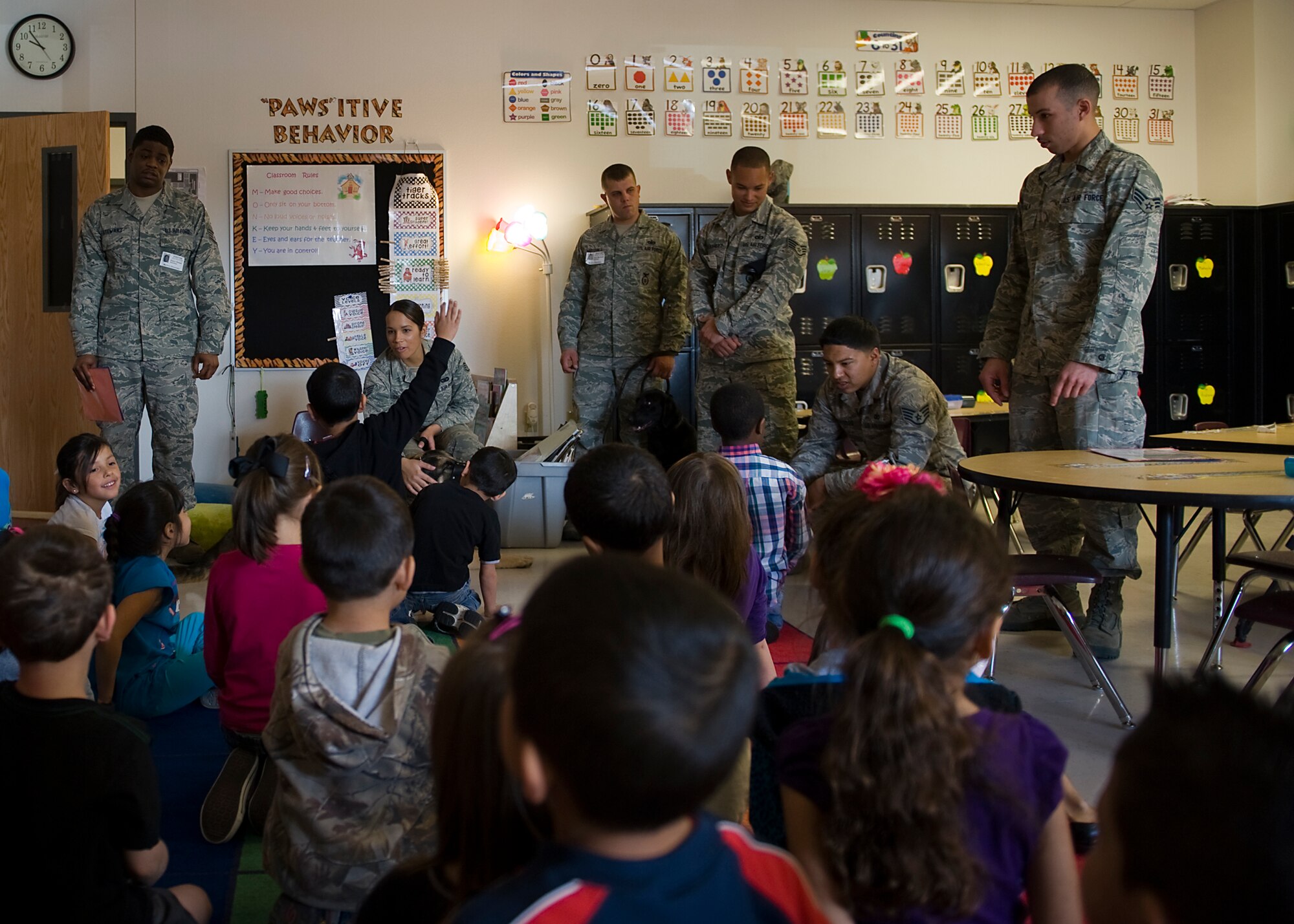 Children from Martinez Elementary School ask Dyess Airmen questions about their jobs during a school visit March 7, 2013, in Abilene, Texas. During the visit, children had the opportunity to interact with Airmen from security forces, maintenance and public affairs. The Airmen talked to the children about their jobs and why they joined the Air Force. At the end of the visit, students read letters to the Airmen thanking them for their service. (U.S. Air Force photo by Airman 1st Class Damon Kasberg/ Released)