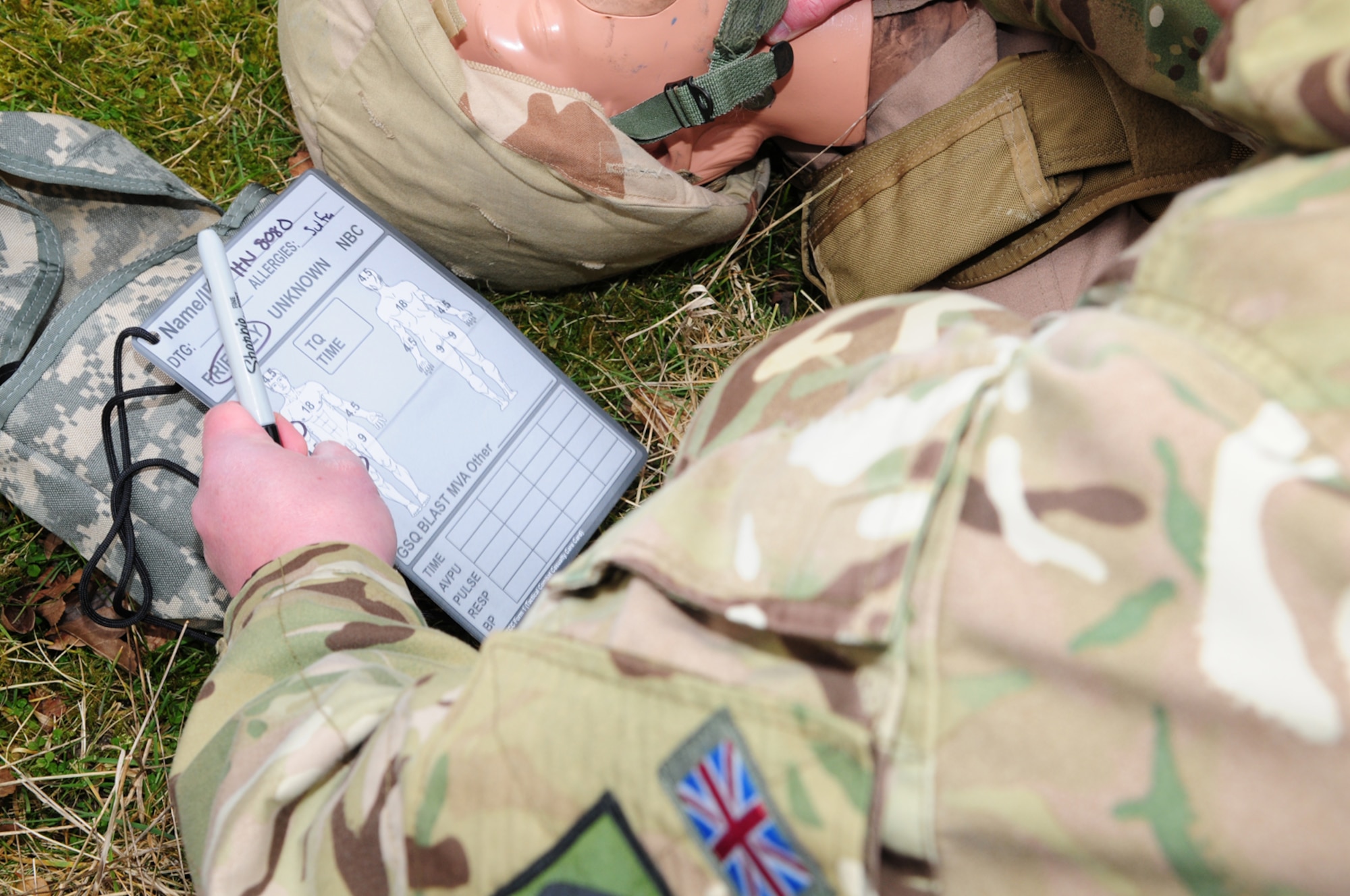 A British Army soldier from 19 Regiment Royal Artillery from Tidworth, Wiltshire, completes a casualty’s MIST card March 6, 2013, listing mechanism, injury sustained, symptoms and treatment given at Stanford Training Area, near Thetford, England. The card is then attached to the casualty as he or she is put on a casualty evacuation vehicle, providing vital information for medics, allowing them to keep track of injuries, treatments and any medication given to patients. Members of the 352nd Special Operations Support Squadron Medical Element provided training to personnel from 19 Regiment and 3 Battalion The Rifles, from Edinburgh, Scotland. (U.S. Air Force photo by Karen Abeyasekere/Released)