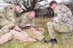 From left, Bombardier Dan Needham from Coalville, Leicestershire; Warrant Officer Class 2 David Cooper from Tidworth, Wiltshire; and Lt. Rob Fidler from Aberdeen, Scotland, all 19 Regiment Royal Artillery in Tidworth, Wiltshire, quickly perform necessary checks on a simulated casualty during training in field conditions March 6, 2013, at Stanford Training Area, near Thetford, England. The British Army soldiers, all Joint Tactical Air Controllers, spent two days learning about U.S. medical techniques from members of the 352nd Special Operations Support Squadron Medical Element, from RAF Mildenhall. The British soldiers and American Airmen worked together sharing knowledge and further building partnerships to help prepare them for emergency situations in a deployed environment. (U.S. Air Force photo by Karen Abeyasekere/Released)
