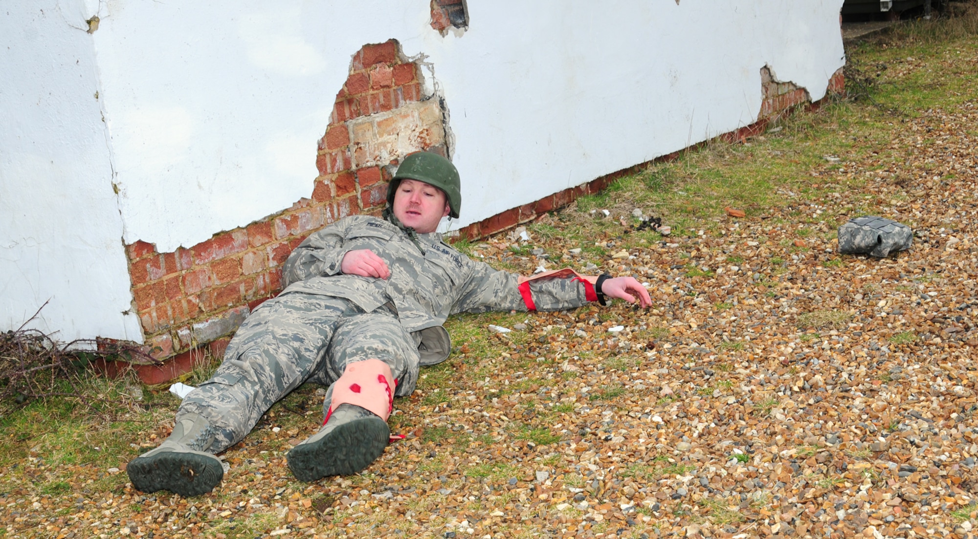 Master Sgt. Scott Piper, 352nd Special Operations Support Squadron Medical Element flight chief, from Las Vegas, plays the role of a casualty in field conditions awaiting British Army Joint Tactical Air Controllers to find him and provide medical treatment during a training scenario March 6, 2013, at Stanford Training Area, near Thetford, England. Piper and other U.S. Air Force members from the 352nd SOSS spent time conducting combat medical refresher training as an ancillary part of a U.K. exercise held at STANTA range. (U.S. Air Force photo by Karen Abeyasekere/Released)
