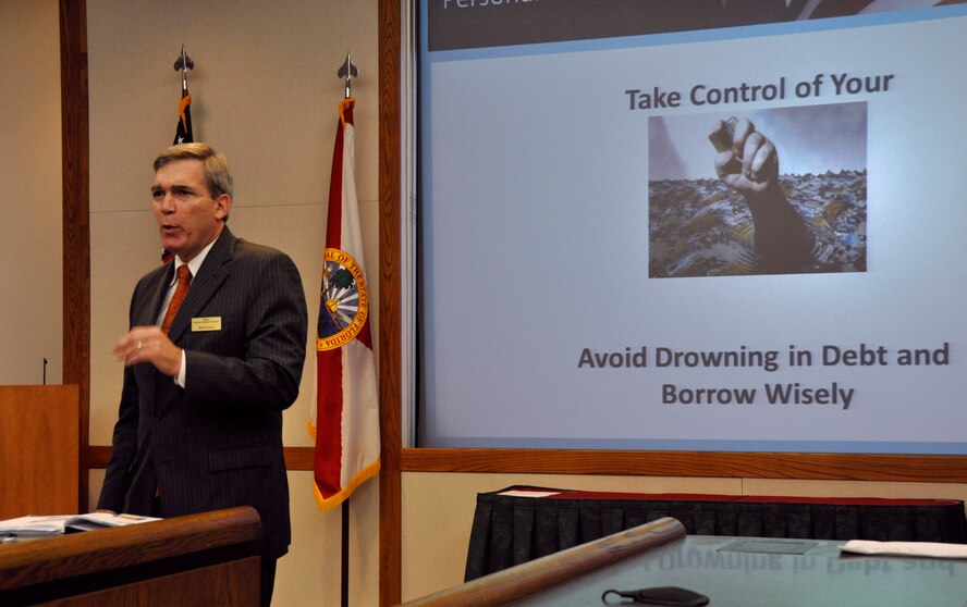 Mr. Mark H. Huston, Military and Family Life Consultant Program personal financial counselor, addresses an audience during a financial awareness briefing at Homestead Air Reserve Base, Fla., March 2. (U.S. Air Force photo/Staff Sgt. Lou Burton)