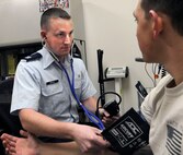 Capt. Timothy Weigle, Randolph Clinic Pharmacy officer in charge, takes a blood pressure reading Monday at the Randolph pharmacy.  (U. S. Air Force photo by Don Lindsey)