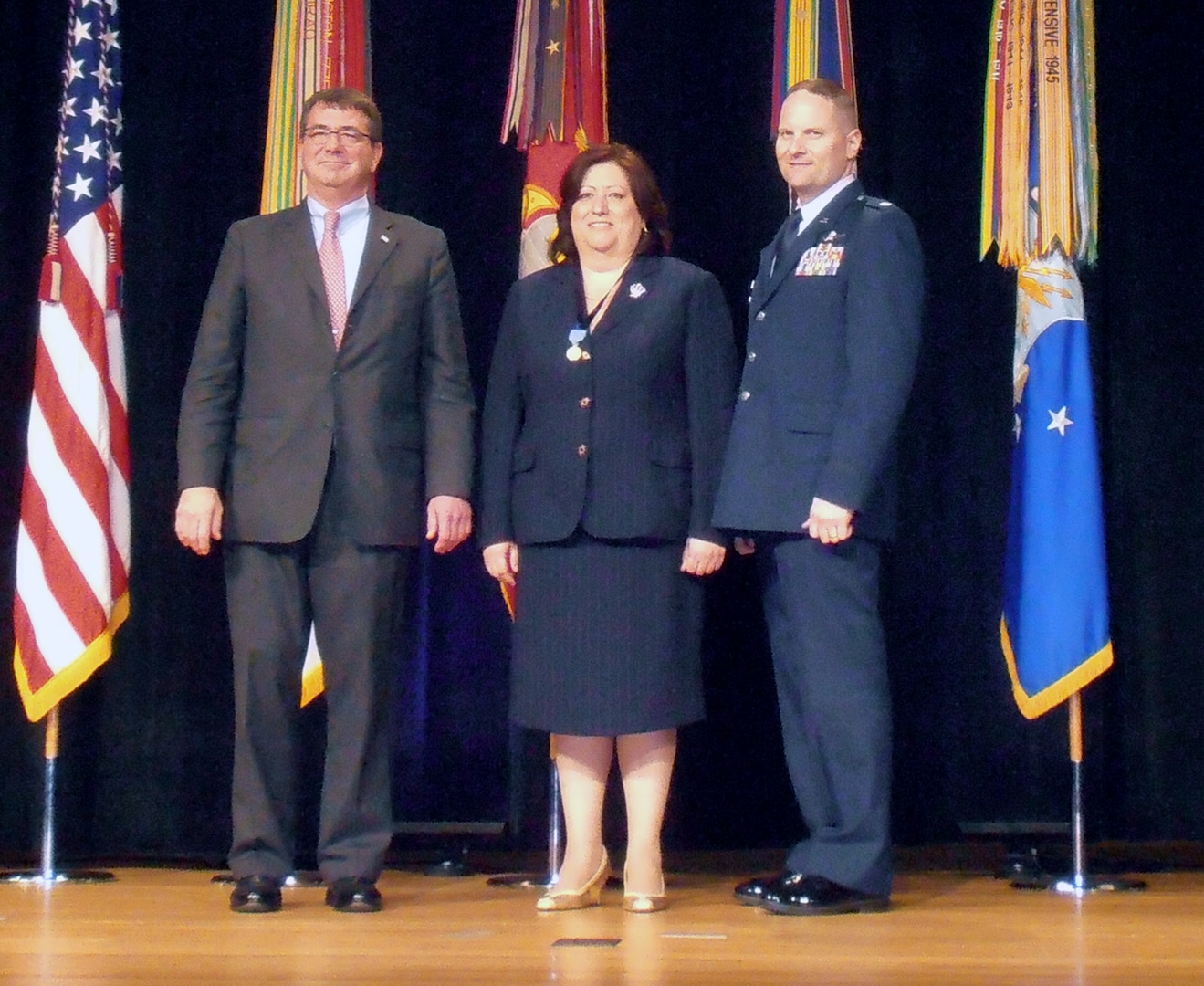 From left, Deputy Secretary of Defense Ashton Carter, Angelica Collazo, a senior analyst with the 92nd Information Operation Squadron at Joint Base San Antonio-Lackland and Lt. Col. David Neuman, former 92 IOS commander, pose after Collazo received her award. Collazo was recognized for her work with cyber space security and received the Defense Distinguished Civilian Service Award during a ceremony at the Pentagon in Wash., D.C. recently. The award is the highest honor given by the Secretary of Defense to career civilian personnel. (Photo courtesy DOD/Released)