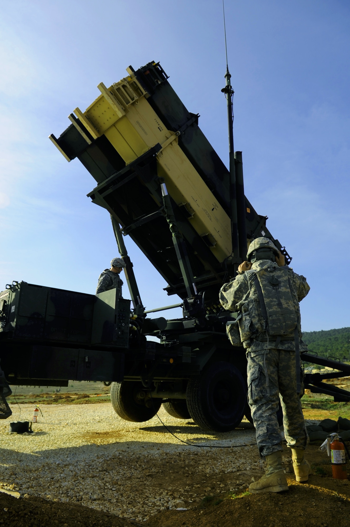 U.S. Army Spc. Marcus Bebe, watches U.S. Army Spc. Charles Chesbro, 3rd Battalion, 2nd Air Defense Artillery maintainers from Fort Sill, Okla., inspect a Patriot launching station Feb. 28, 2103, near Gaziantep, Turkey. Patriot batteries are deployed to Turkey to augment Turkish air defense capabilities. (U.S. Air Force photo by Senior Airman Daniel Phelps/Released)