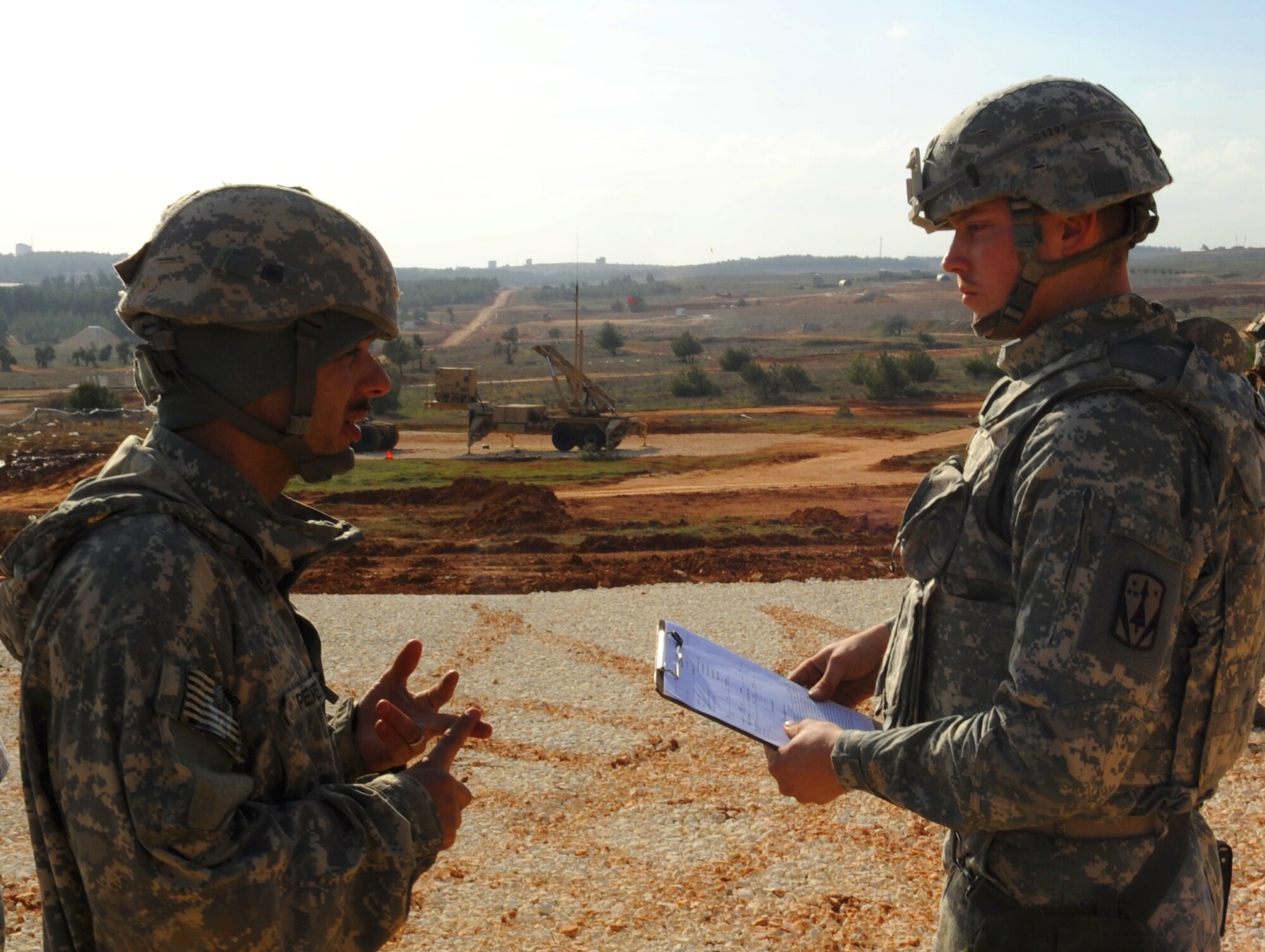 U.S. Army Sgt. Zachary Perez and U.S. Army Spc. Charles Chesbro, 3rd Battalion, 2nd Air Defense Artillery Patriot launching station maintainers, go over Patriot launching station checklists Feb. 28, 2013, near Gaziantep, Turkey. U.S. Army Patriot batteries from Fort Sill, Okla. are deployed to Turkey as part of NATO’s commitment to Turkey’s security. (U.S. Air Force photo by Senior Airman Daniel Phelps/Released)