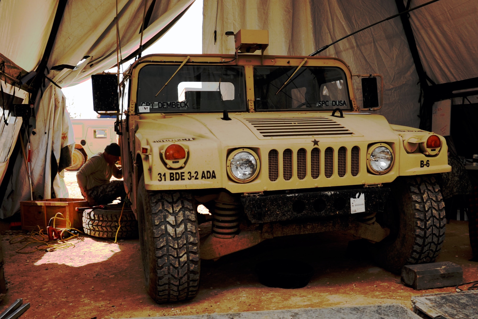 U.S. Army Staff Sgt. Gaston Henderson, 3rd Battalion, 2nd Air Defense Artillery maintainer, works on a Humvee in a maintenance tent Feb. 28, 2013, near Gaziantep, Turkey. The 3-2 ADA from Fort Sill, Okla. is deployed to Turkey as part of a cooperative solution to promote regional stability by augmenting Turkey’s air defenses. (U.S. Air Force photo by Senior Airman Daniel Phelps/Released)