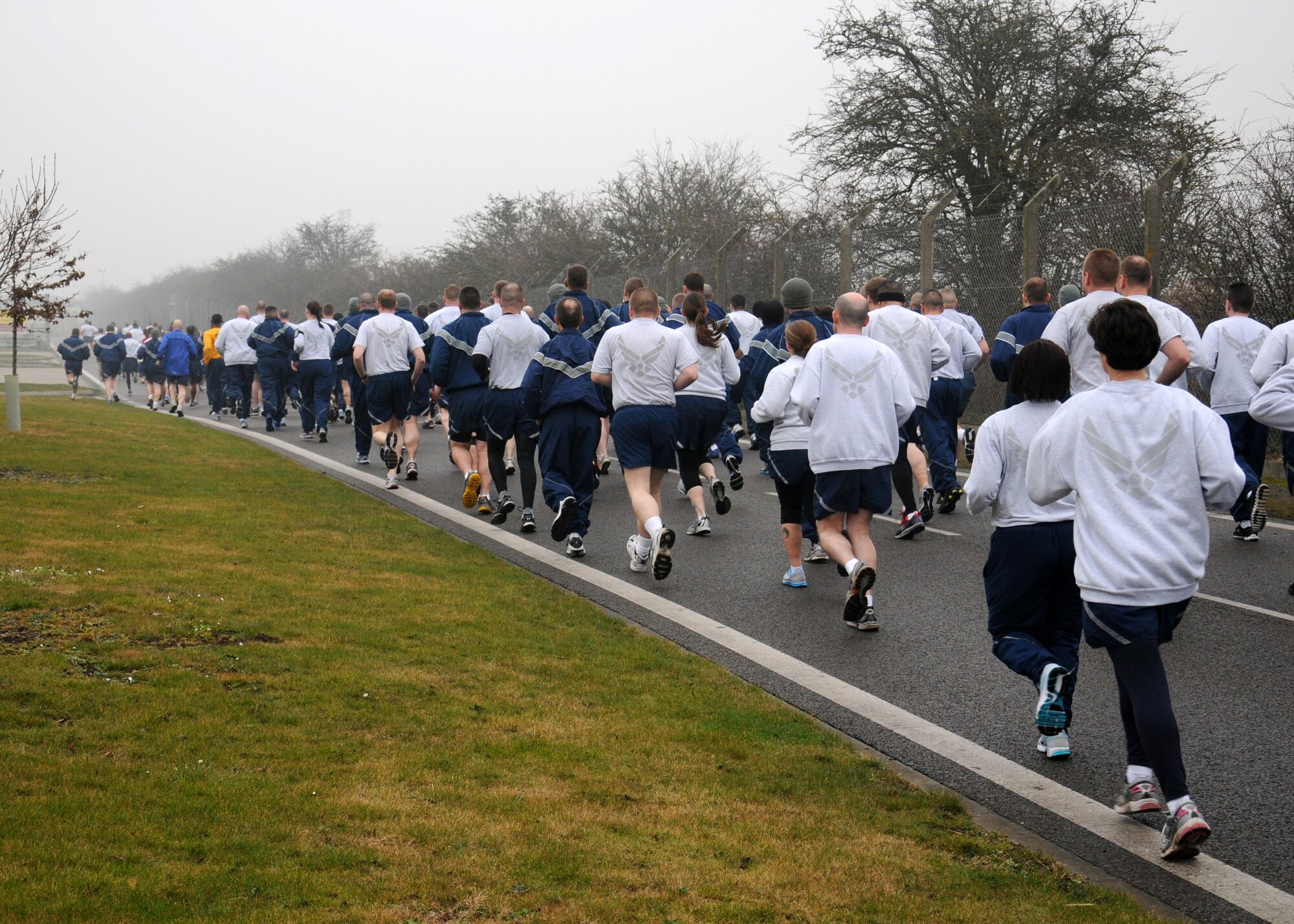 Team Mildenhall members take part in a wing run March 8, 2013, on Perimeter Road near the Hardstand Fitness Center on RAF Mildenhall, England. Many use the run as a chance to make sure they are “fit to fight,” while others use it for fun and fresh-air, as well as a time to meet other Team Mildenhall members they wouldn’t normally get to spend time with. (U.S. Air Force photo by Gina Randall/Released)