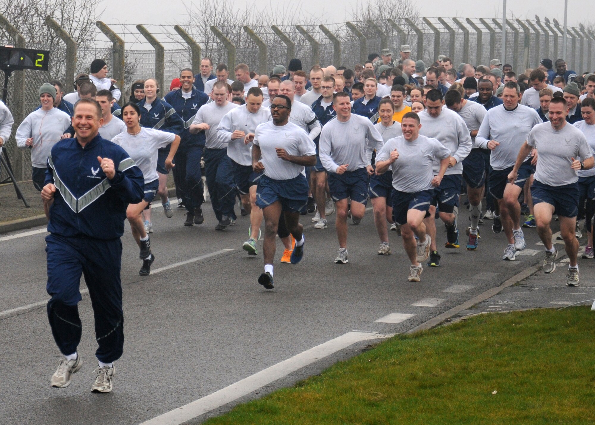 Col. Kyle Voigt, 100th Air Refueling Wing vice commander, leads his Airmen in improving their fitness during a wing run March 8, 2013, on Perimeter Road near the Hardstand Fitness Center on RAF Mildenhall, England. The run takes place on the first Friday of every month and is mandatory for all 100th Air Refueling Wing military personnel, but tenant units and base ID card holders 13-years and older are welcome to attend. (U.S. Air Force photo by Gina Randall/Released)