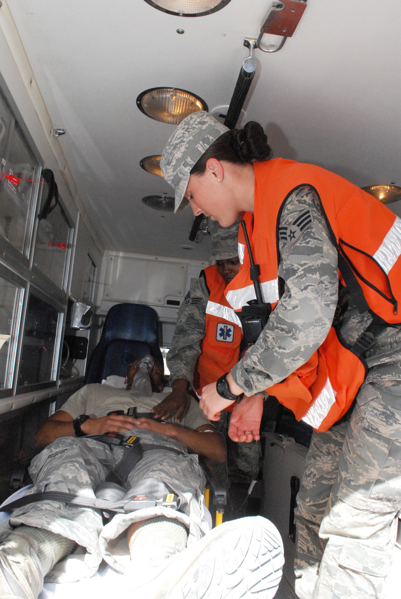Senior Airmen Sonni Hamill and Diana Ceus, medical technicians, prepare to transfer a patient from the ambulance to the base medical clinic, Mar. 8. The 379th Expeditionary Medical Group serves all the emergency and transient medical needs for the 379th Air Expeditionary Wing and tenant units. (U.S. Air Force photo/Master Sgt. Christian Michael)