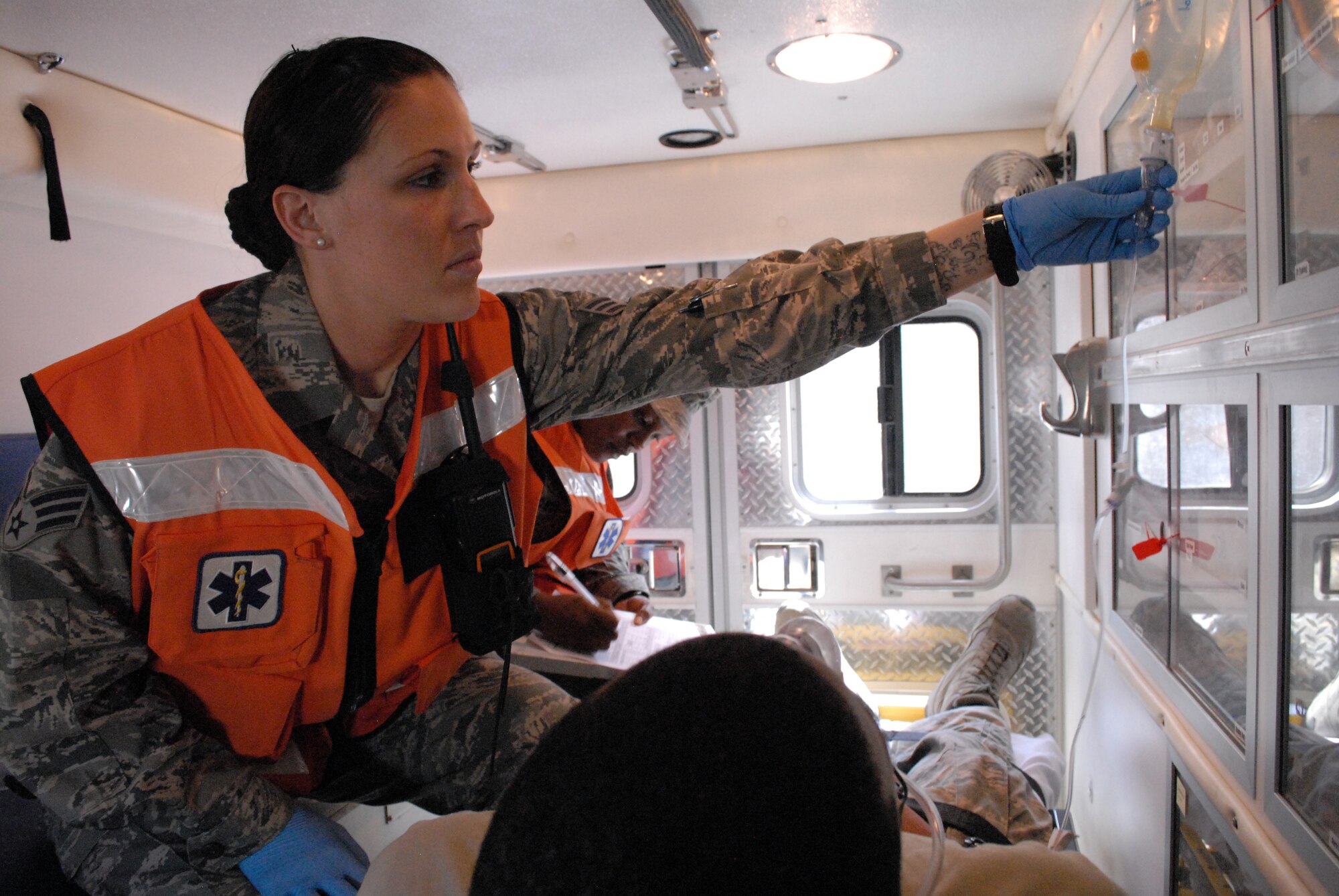 Senior Airman Sonni Hamill, medical technician, checks a patient's fluid lines before transporting him via ambulance, Mar. 8. The 379th Expeditionary Medical Group serves all the emergency and transient medical needs for the 379th Air Expeditionary Wing and tenant units. (U.S. Air Force photo/Master Sgt. Christian Michael)