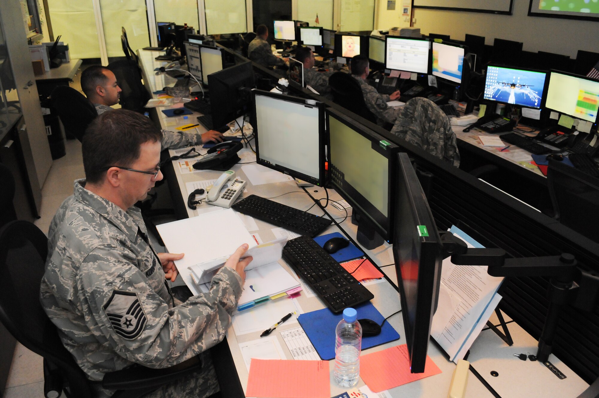 Maintenance operations center superintendent Master Sgt. Matthew Kornprobst reviews continuity, Mar. 7, while his controllers coordinate aircraft maintenance for the wing. The 379th Expeditionary Maintenance Group MOC manages all maintenance operations for units assigned to the 379th Air Expeditionary Wing, ranging from scheduling maintenance, preventing loss of covering by staggering non-maintenance activities, and upchanneling important information to appropriate leadership to make informed operational decisions. (U.S. Air Force photo/Master Sgt. Christian Michael)