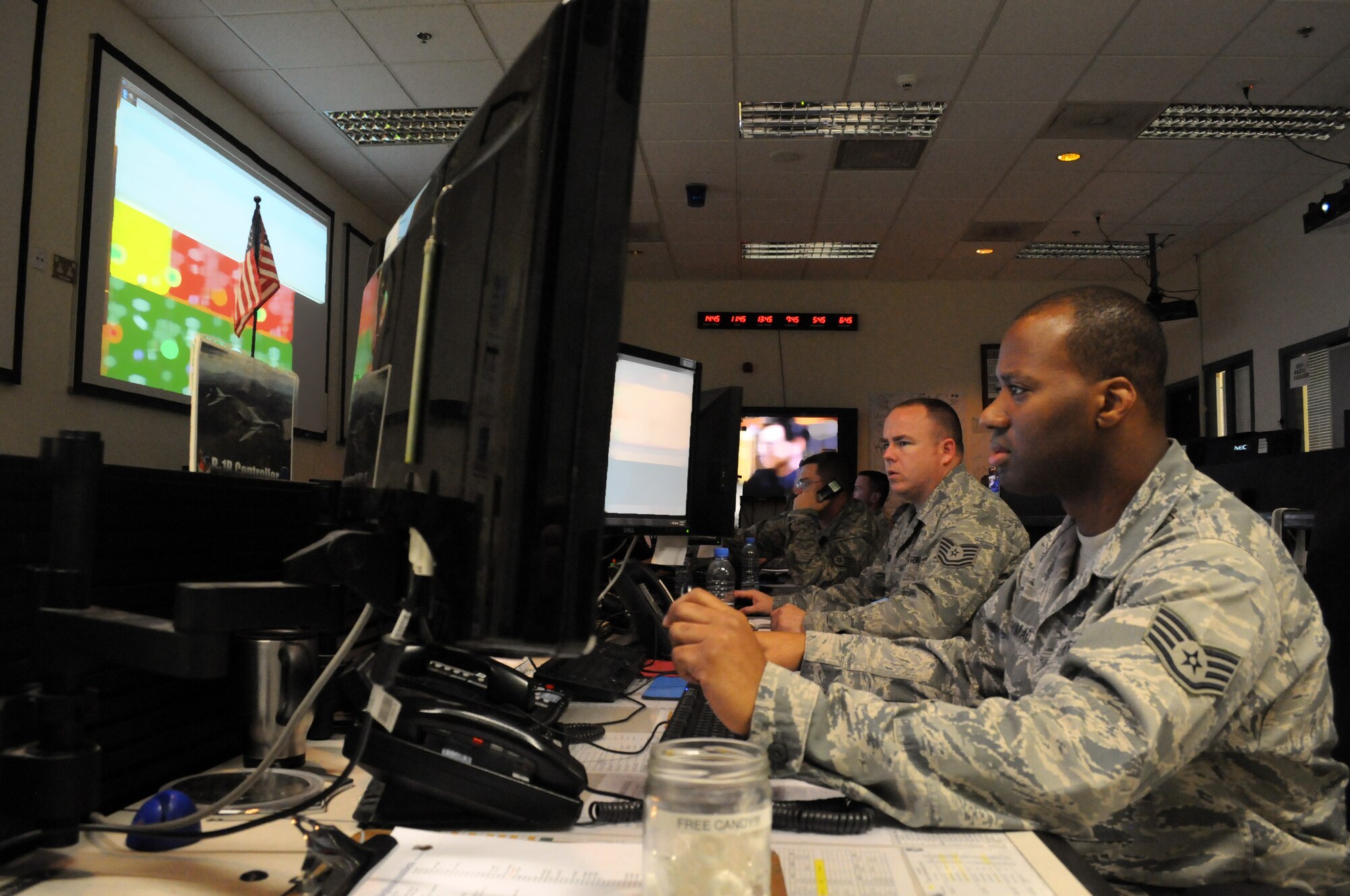 Junior B1-B maintenance operations center controller Staff Sgt. Nasir Ahmad, right, and RC-135/E-8 MOC controller Tech. Sgt. Arthur Trimble, coordinate all maintenance scheduling and coordination for their respective airframes, Mar. 7. The 379th Expeditionary Maintenance Group MOC manages all maintenance operations for units assigned to the 379th Air Expeditionary Wing, ranging from scheduling maintenance, preventing loss of covering by staggering non-maintenance activities, and upchanneling important information to appropriate leadership to make informed operational decisions. (U.S. Air Force photo/Master Sgt. Christian Michael)