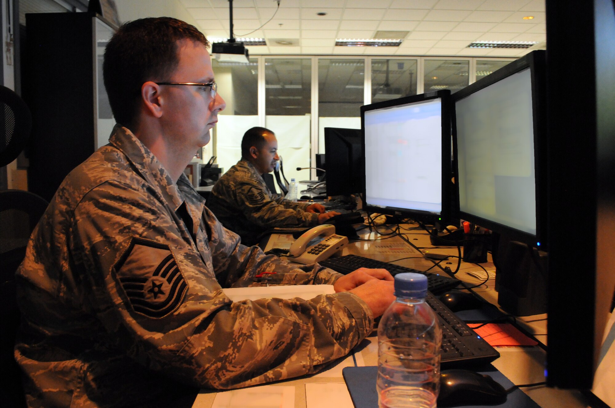Maintenance operations center superintendent Master Sgt. Matthew Kornprobst reviews continuity, Mar. 7, while senior controller Master Sgt. Daniel Vleasquez manages aircraft maintenance operations for the wing. The 379th Expeditionary Maintenance Group MOC manages all maintenance operations for units assigned to the 379th Air Expeditionary Wing, ranging from scheduling maintenance, preventing loss of covering by staggering non-maintenance activities, and upchanneling important information to appropriate leadership to make informed operational decisions. (U.S. Air Force photo/Master Sgt. Christian Michael)