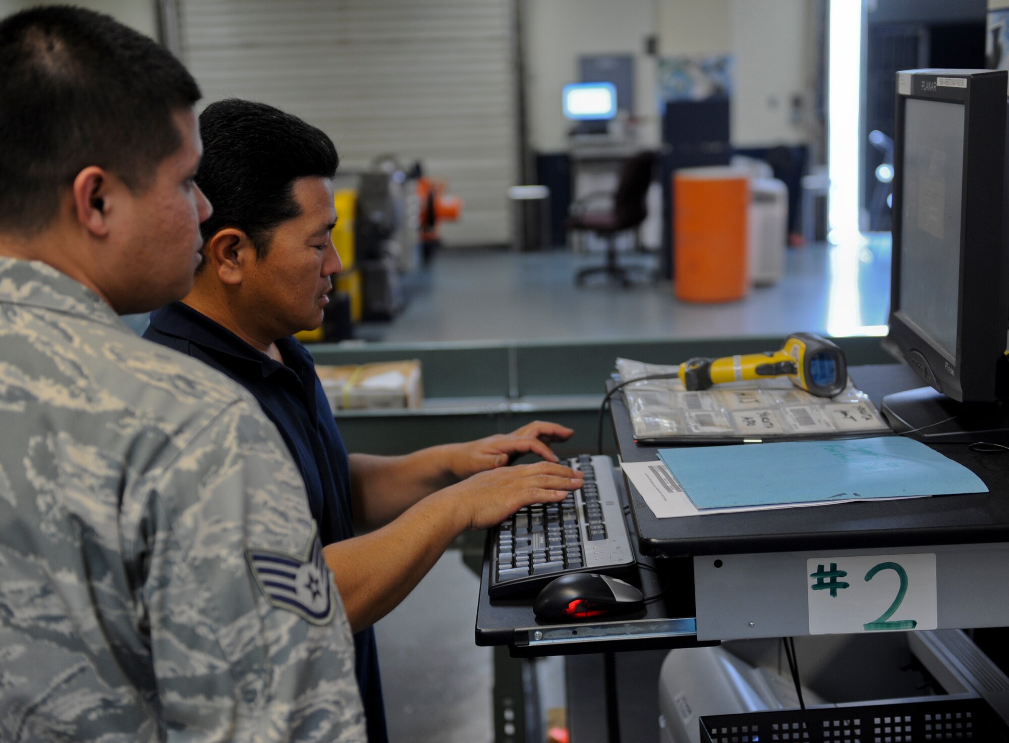 Hiroyusu Kuda, Detachment 3 Pacific Air Forces Air Postal Squadron postal specialist, inserts information into a computer at building 125 on Kadena Air Base, Japan, March 11, 2013. PACAF's Detachment 3, APS, serves as the Department of Defense's sole agency for air transport of military mail to and from Okinawa, and manages mail-related customs and inspections. (U.S. Air Force photo/Airman 1st Class Justin Veazie)
