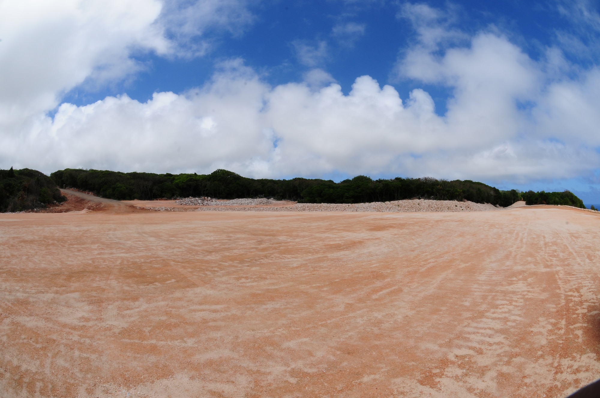 Site 14 was contaminated with harmful substances such as polychlorinated biphenyl and asbestos and is one of 80 sites Team Andersen is required to restore by 2014. After the affected soil was removed, the 36th Civil Engineer Squadron sloped dirt around the original area and constructed a trench to divert storm water away from the site so as not to risk trace amounts of contaminated soil flowing over the edge of the cliff. (U.S. Air Force photo by Senior Airman Robert Hicks/Released)