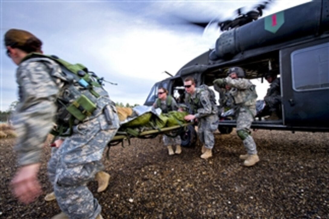 U.S. Army medical personnel offload a simulated injured soldier from a U.S. Army HH-60L Black Hawk helicopter at the Joint Readiness Training Center on Fort Polk, La., on Feb. 23, 2013.  Service members at the center are educated in combat patient care and aeromedical evacuation in a simulated combat environment.  