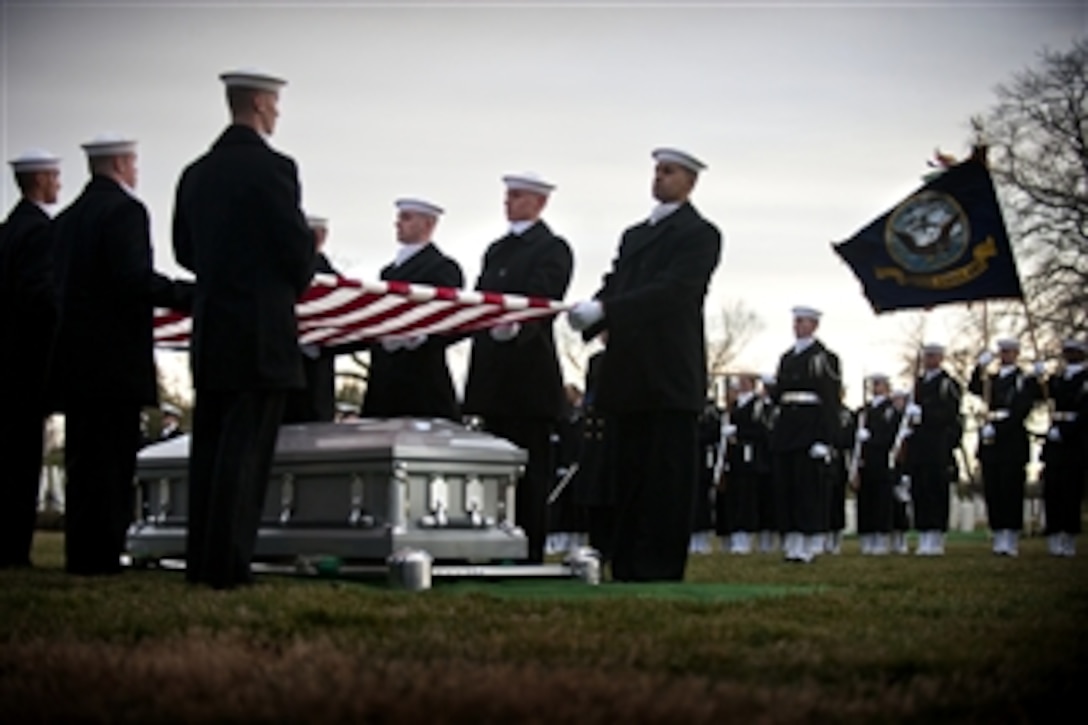 Sailors from the U.S. Navy Ceremonial Guard hold the flag over the casket bearing the remains of a sailor recovered from the ironclad USS Monitor during burial services at Arlington National Cemetery in Arlington, Va., on March 8, 2013.  The Monitor sank off Cape Hatteras, N.C., in 1862.  