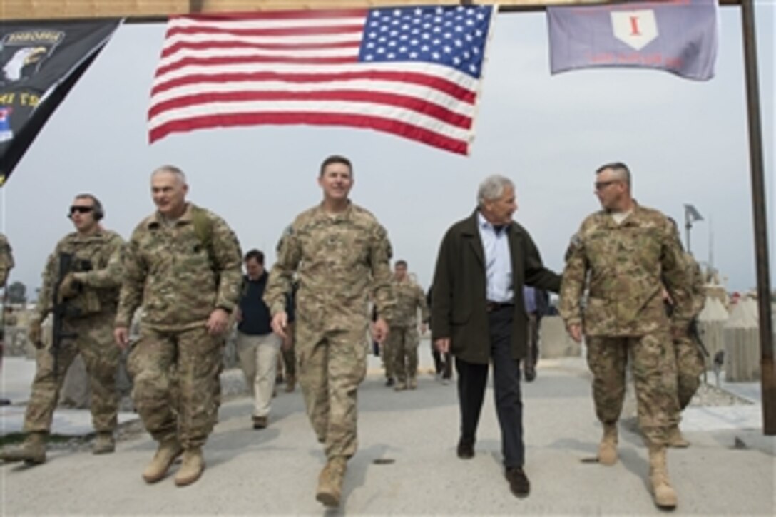 Secretary of Defense Chuck Hagel, second from right, talks to Command Sgt. Maj. Thomas Eppler in Jalalabad, Afghanistan, on March 9, 2013.  Lt. Gen. James Terry, second from left, and Col. Joseph McGee, center, join Hagel as he walks to a troop event.  Hagel is in Afghanistan on his first trip as secretary of defense to visit U.S. troops, NATO leaders, and Afghan counterparts.  