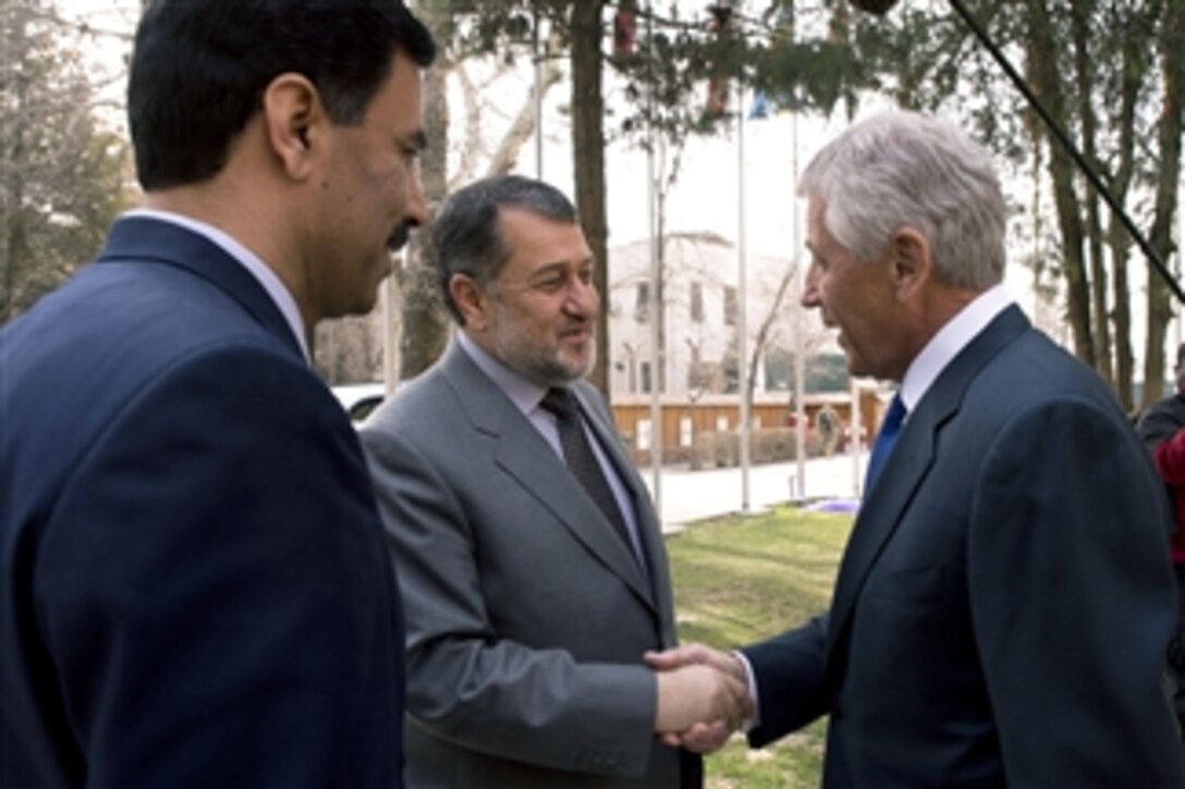 Secretary of Defense Chuck Hagel, right, shakes hands with Afghan Defense Minister Bismillah Khan Mohammadi in Kabul, Afghanistan, on March 10, 2013.  Hagel is in Afghanistan on his first trip as secretary of defense to visit U.S. troops, NATO leaders, and Afghan counterparts.  