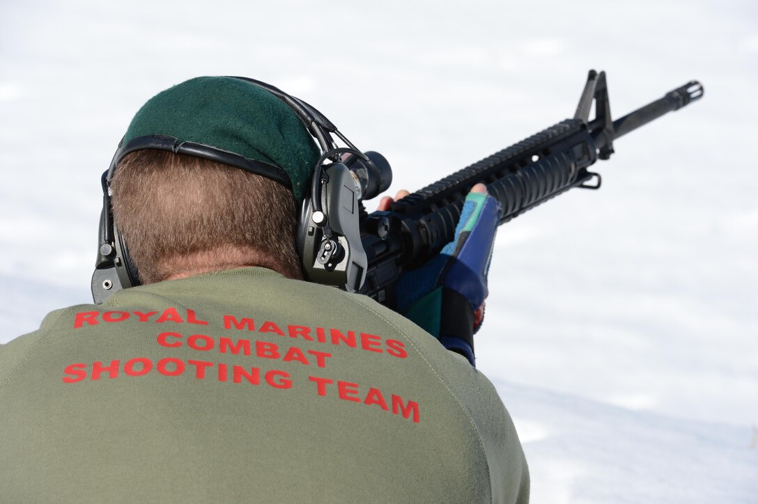 Sgt. Charlie Dixon, Royal Marines Combat Shooting Team, takes aim at a target during a training session with the U.S. Marine Corps Shooting Team at Weapon Training Battalion’s Range 4 on March 7. Even with snow covering the Range and the wind frequently blowing off their covers, the Marines practiced with their weapons as if it was a regular bright and sunny day.
