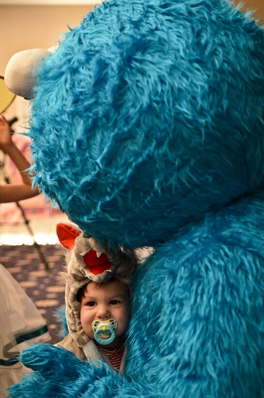 Gavyn, 19 months, hugs one of his favorite Sesame Street characters, Cookie Monster, during “Storybook Fantasy Night” at the Clubs at Quantico on March 7. More than 40 children attended the event.