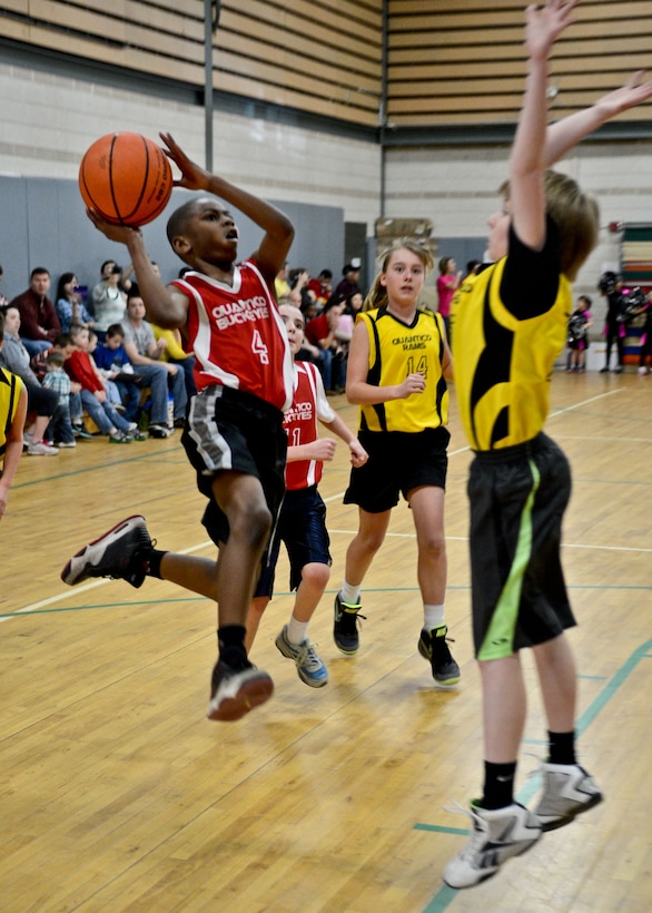 Tez, player for Junior Buckeyes, goes for a lay up during a Marine Corps Community Services’ Quantico Youth Sports’ Basketball League game at the Youth Center on March 9. The Buckeyes beat their opponents, the Rams, during the championship 27-7. 