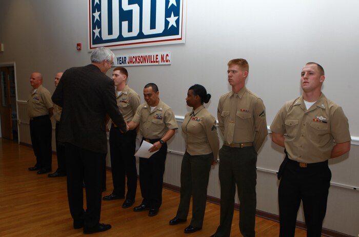 John Falkenbury, the USO of North Carolina president, shakes the hand of a sailor with Medical Logistics Company, 2nd Supply Battalion, 2nd Marine Logistics Group at the USO in Jacksonville, N.C., March 7, 2013.Falkenbury thanked a group of the battalion’s servicemembers for their volunteer work with the organization, which helped update the USO’s food-storage capabilities. 