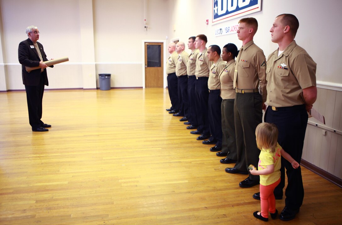 John Falkenbury, the USO of North Carolina president, speaks to Marines and sailors with Medical Logistics Company, 2nd Supply Battalion, 2nd Marine Logistics Group during an award ceremony at the USO in Jacksonville, N.C., March 7, 2013. The servicemembers spent several weeks constructing new shelving and reorganizing the facility’s storage area after the battalion donated more than 6,000 pounds of nonperishable food items.