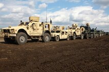 A nine-vehicle convoy waits to depart the staging area for Combat Logistics Battalion 6, 2nd Marine Logistics Group during a field training exercise aboard Camp Lejeune, N.C., Feb. 28, 2013. Thirty-one Marines with the battalion later manned the convoy on a route clearing exercise launched to support a helicopter support team.